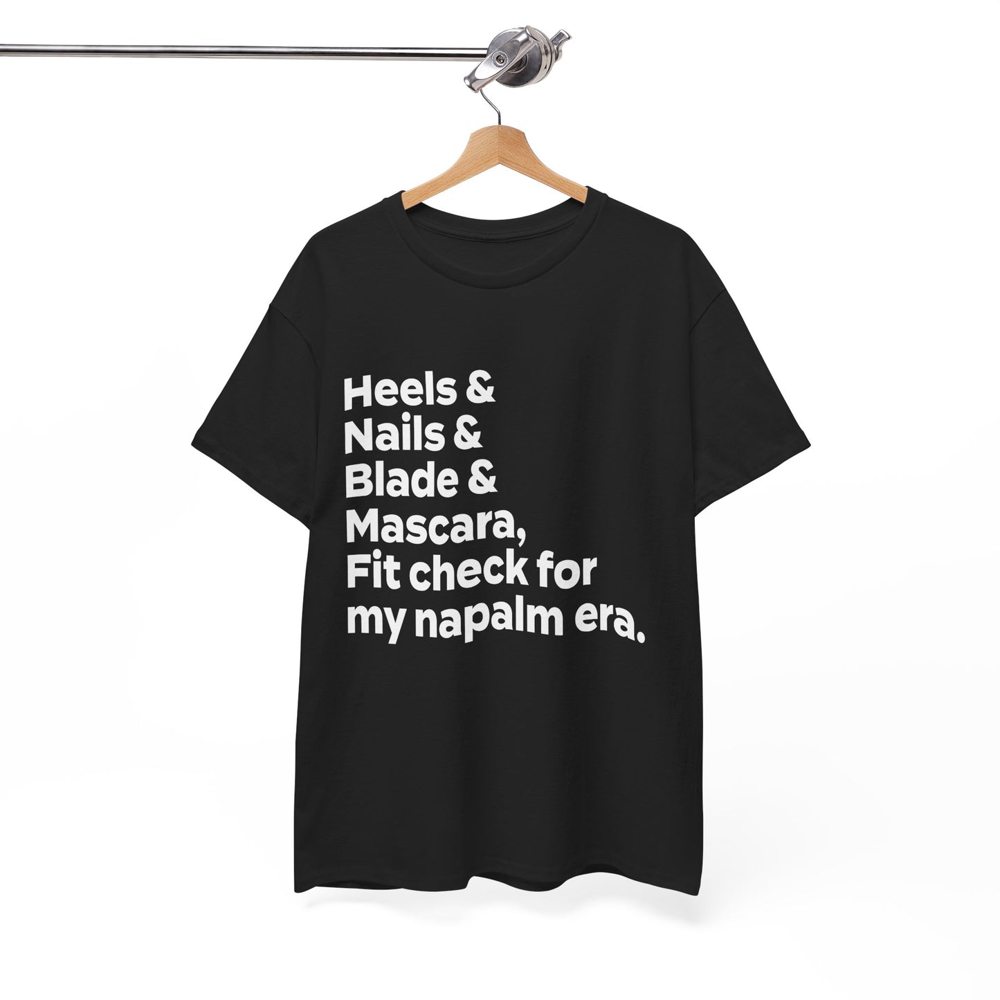 A KPOP Demon Hunters graphic tee featuring the phrase 'heels & nails & blade & mascara, fit check for my napalm era' in bold white lettering.