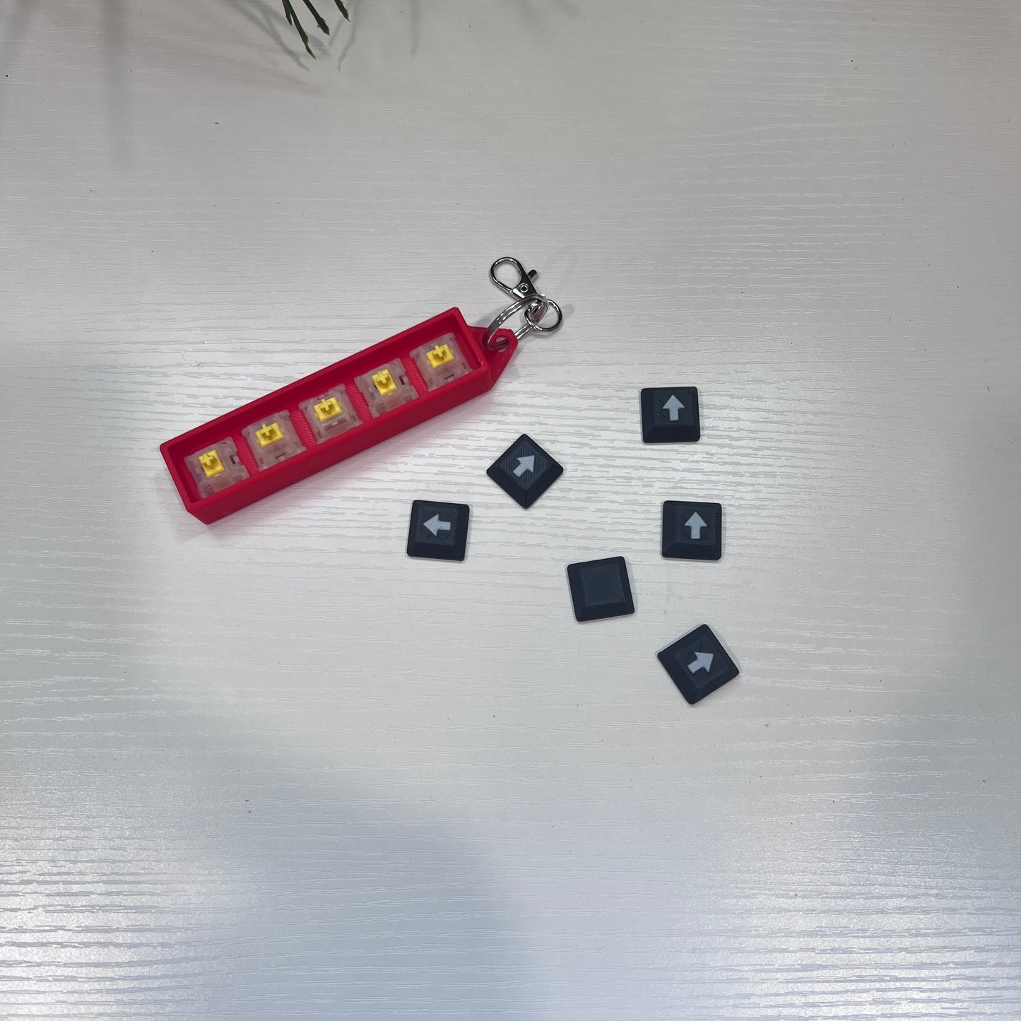 Helldivers 2-inspired keychain clicker featuring mechanical arrow keys. A perfect fidget toy for gamers, stress relief, and tactical clicking action.