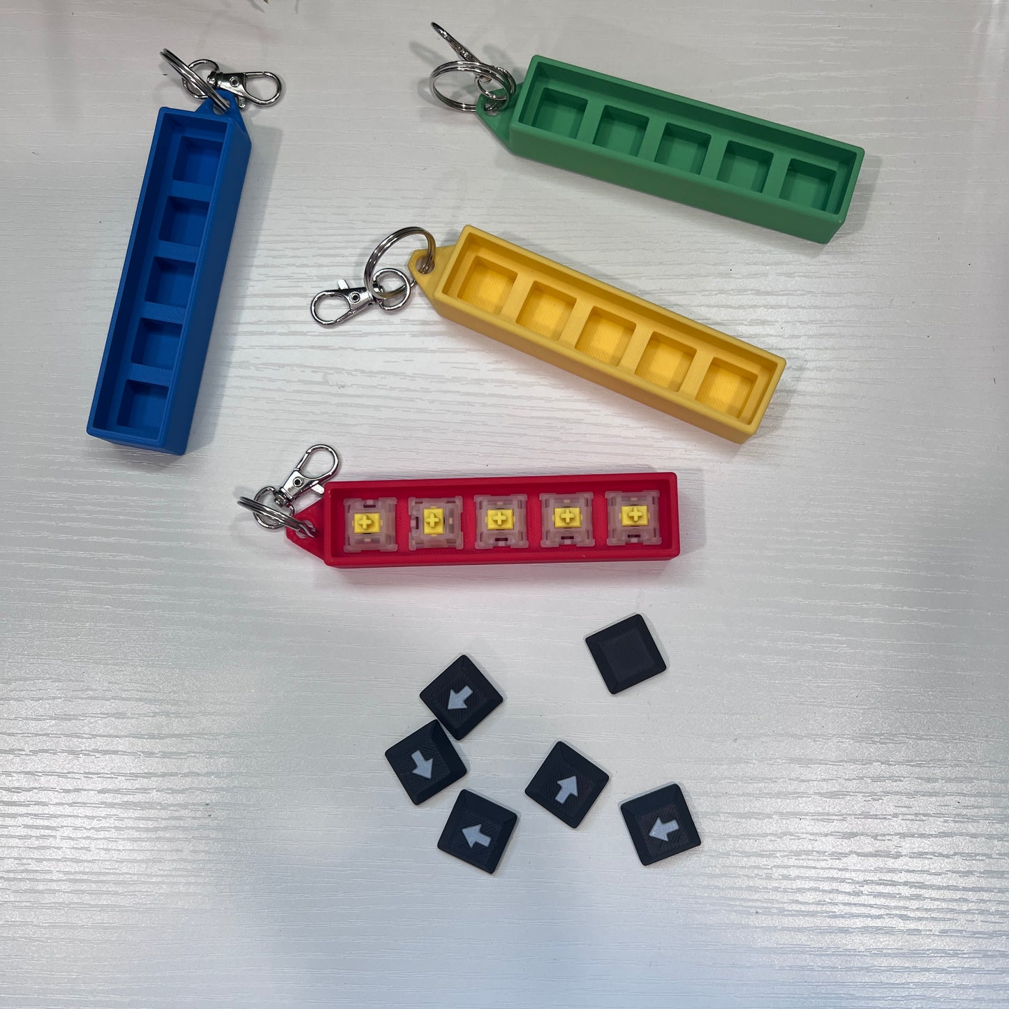 Helldivers 2-inspired keychain clicker featuring mechanical arrow keys. A perfect fidget toy for gamers, stress relief, and tactical clicking action.