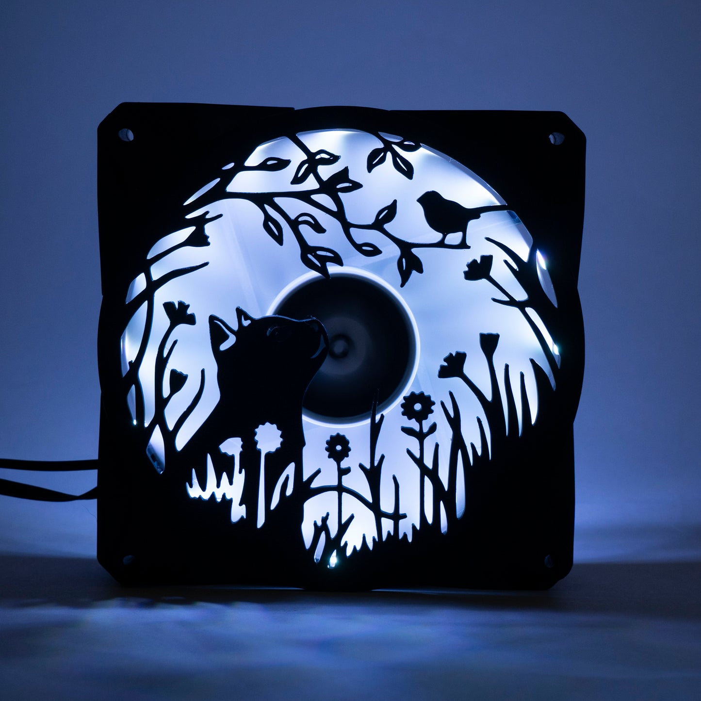 Adorable 3D printed PC fan grill featuring a cat and bird in a garden scene. Adds cozy charm and personality to any gaming or desktop setup.