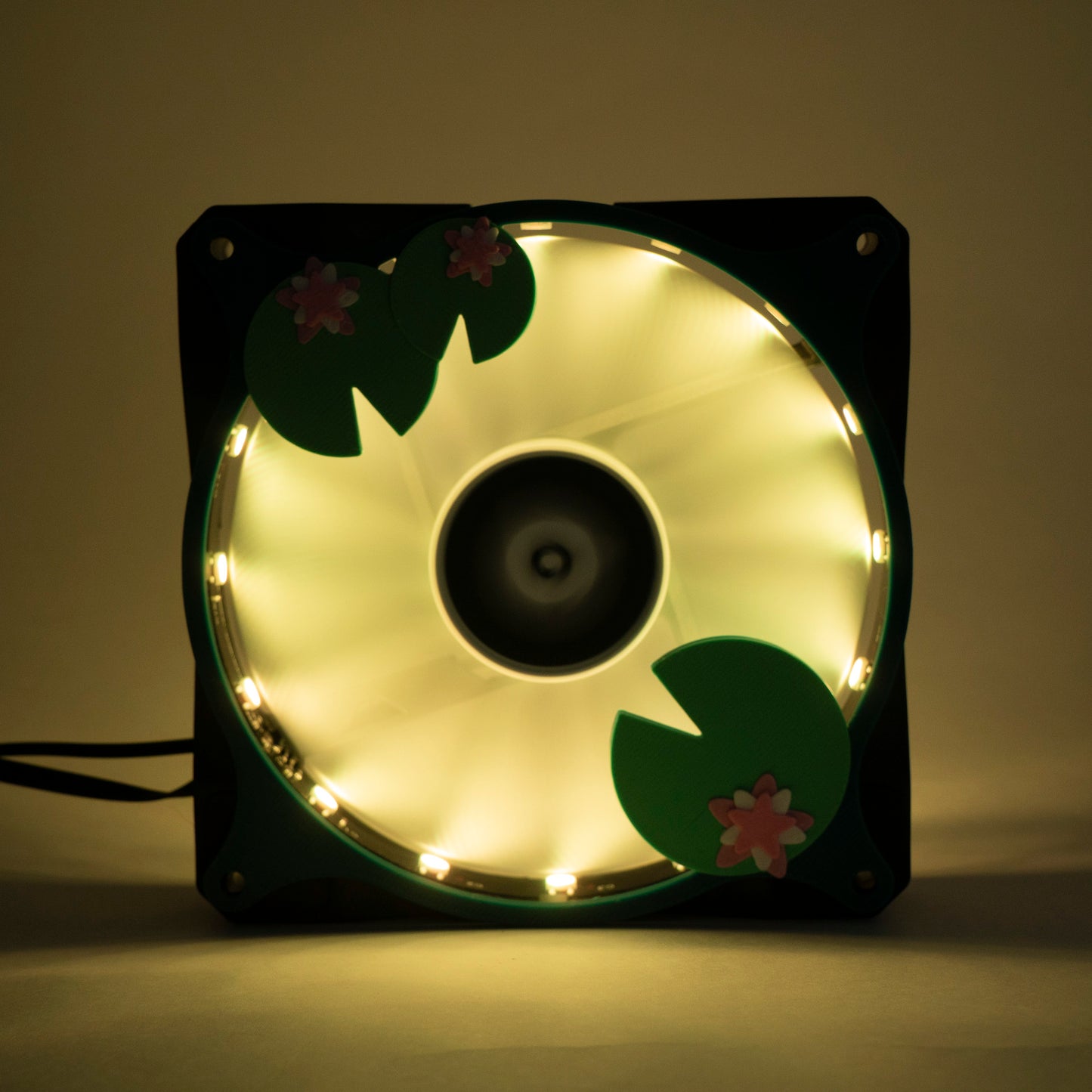 Adorable 3D printed PC fan grill with lily pad and lotus flower design. A cute nature-inspired fan cover perfect for cozy, aesthetic gaming setups.