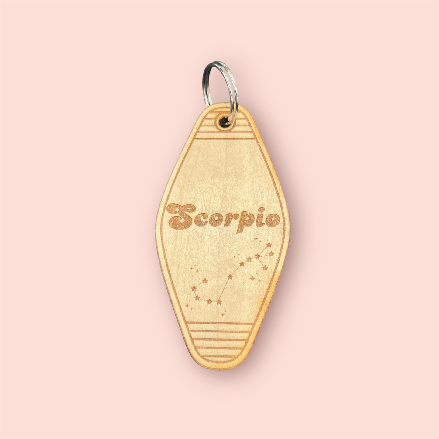 Laser engraved wood motel keychain featuring zodiac names and constellations, perfect for astrology lovers, horoscope fans, and retro gift collectors. This is for the Zodiac sign Scorpio.