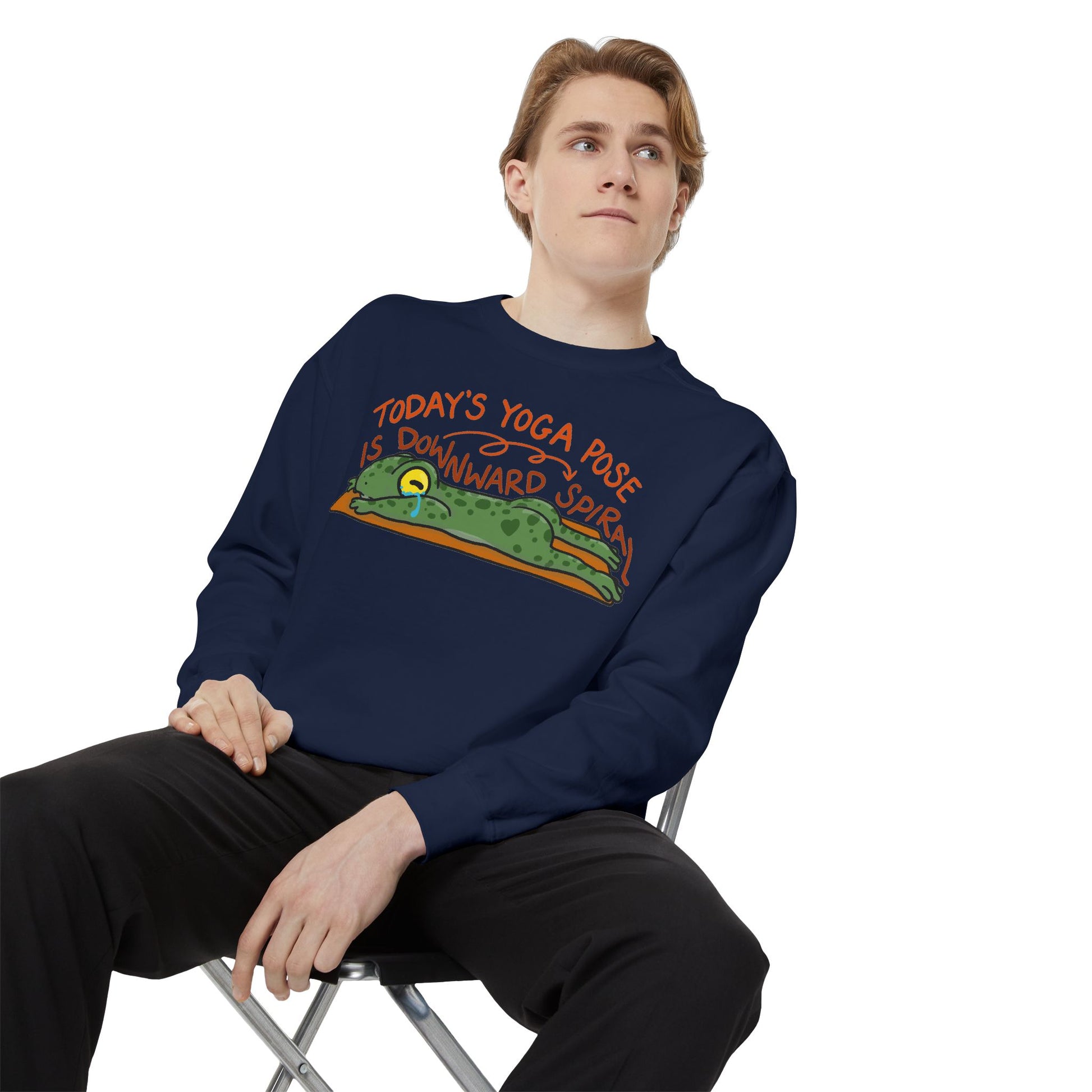 This sweatshirt features a cute, exhausted frog in a yoga pose with the text "Today's Yoga Pose is Downward Spiral." Perfect for yoga enthusiasts and those with a sense of humor.