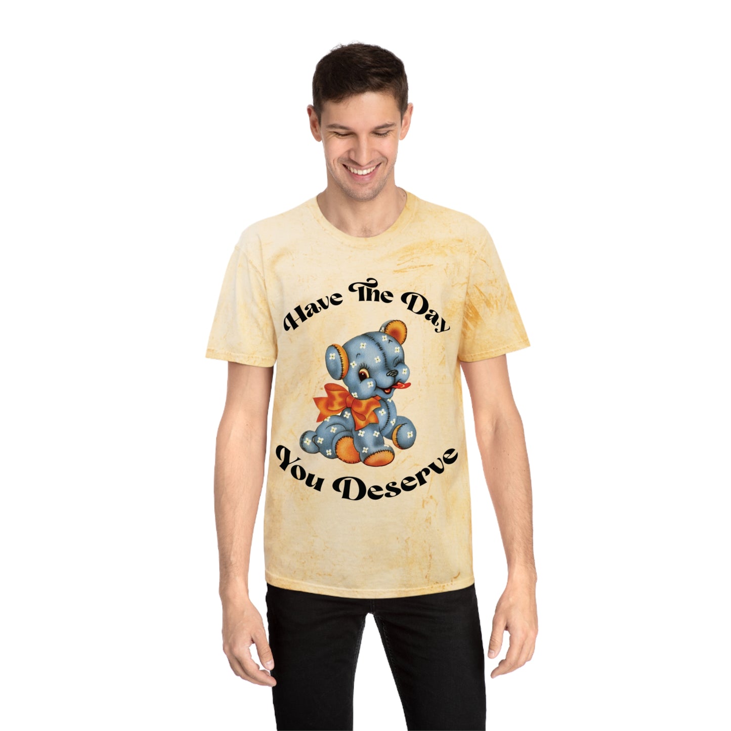 T-shirt with a cute plush bear design in shades of blue, wearing a red bow, accompanied by the playful phrase, Have the Day You Deserve. Casual and relaxed fit for an effortlessly cool look. Available in Blue, Gray, and Citrine.