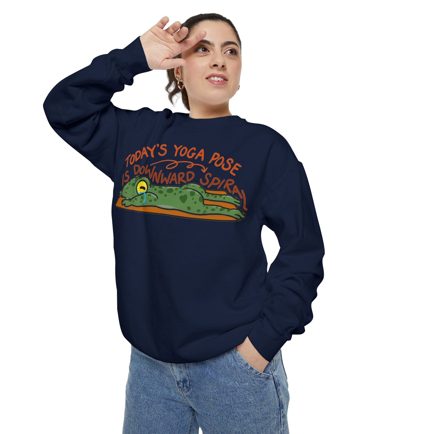 This sweatshirt features a cute, exhausted frog in a yoga pose with the text "Today's Yoga Pose is Downward Spiral." Perfect for yoga enthusiasts and those with a sense of humor.