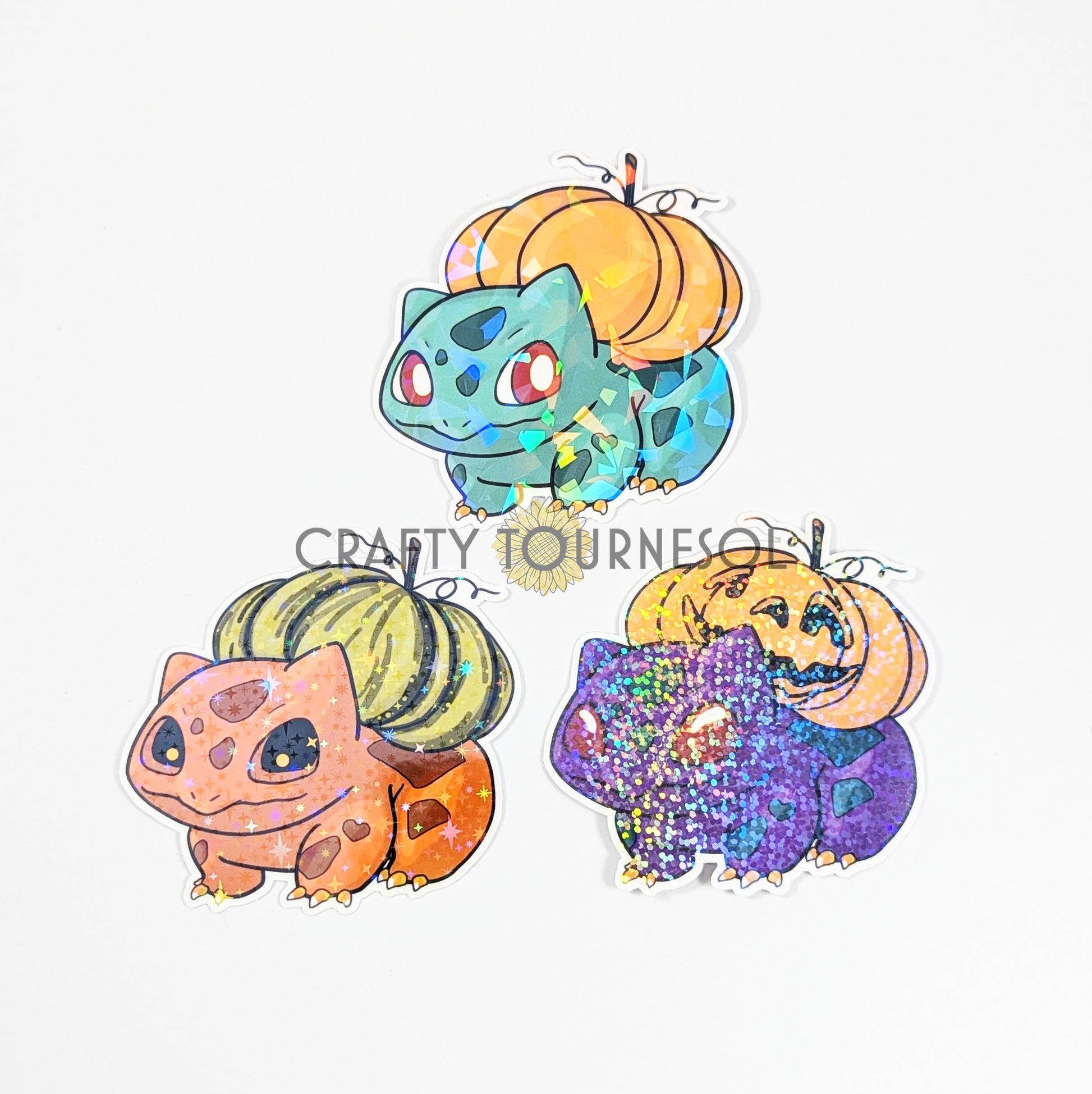 "Three cute, Halloween-themed Bulbasaur stickers featuring pumpkin designs and holographic sparkles. Perfect for Pokemon fans, these adorable stickers add a festive touch with unique pumpkin-inspired details."