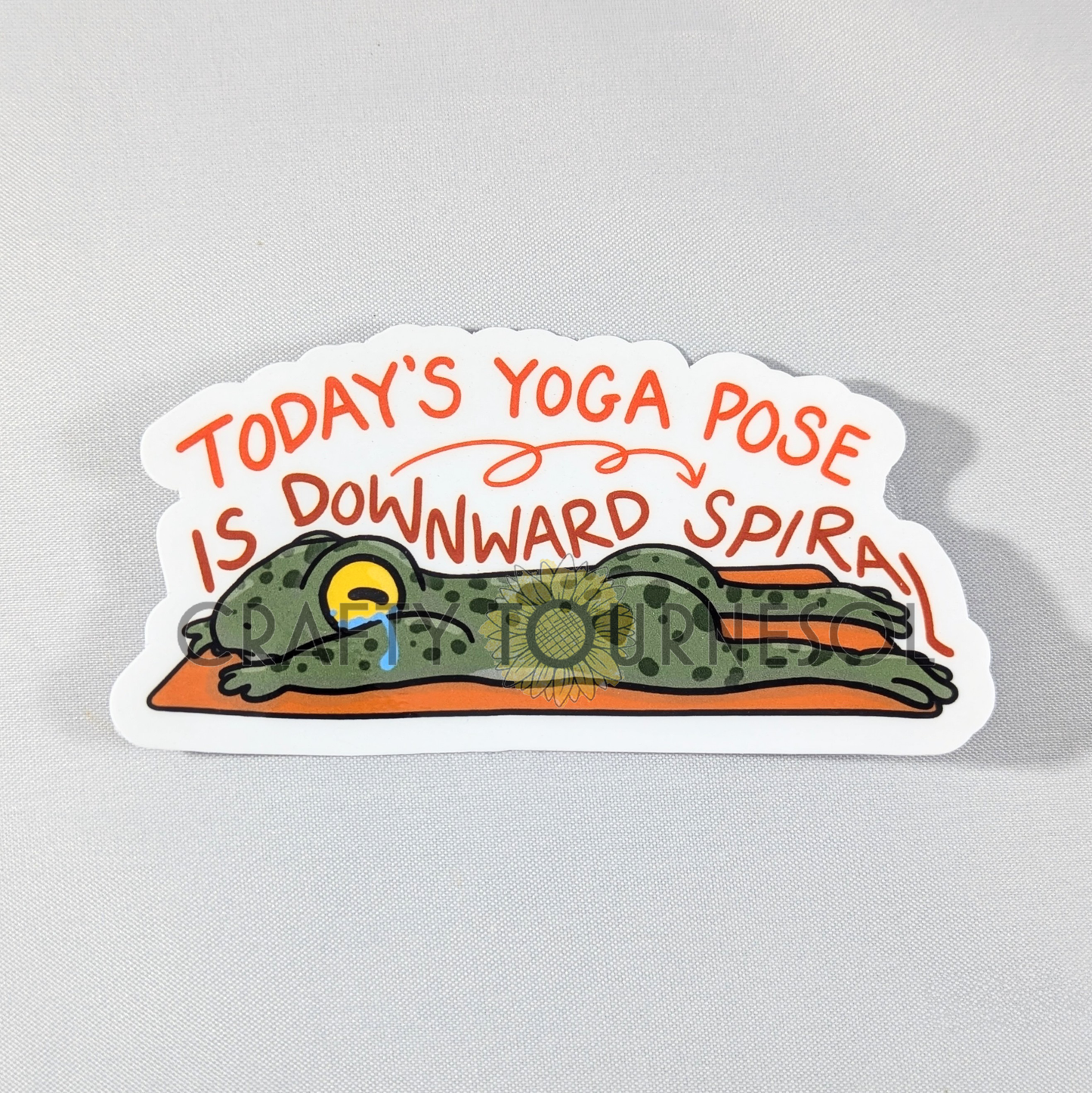 "Funny yoga sticker featuring a tired frog in 'Downward Spiral' pose with humorous text. Perfect for yoga lovers, mental health awareness, or adding a playful touch to water bottles, laptops, or journals."