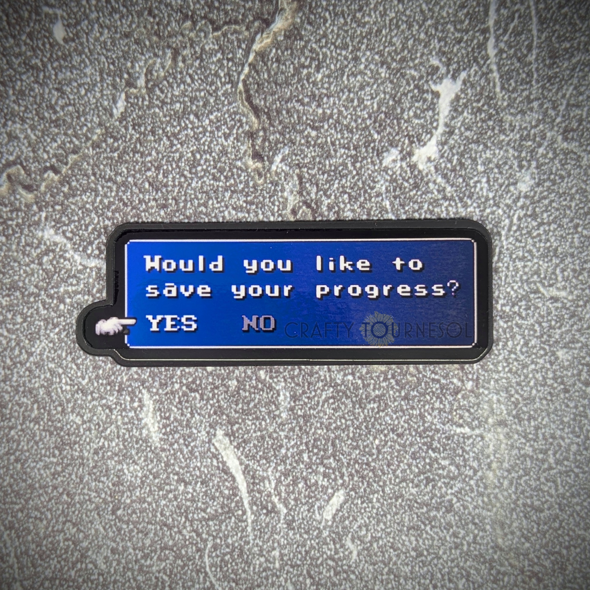 "Pixel art magnet featuring a classic RPG-style save prompt with the text 'Would you like to save your progress? YES NO,' ideal for gamers and nostalgia lovers. Background is a textured gray surface."