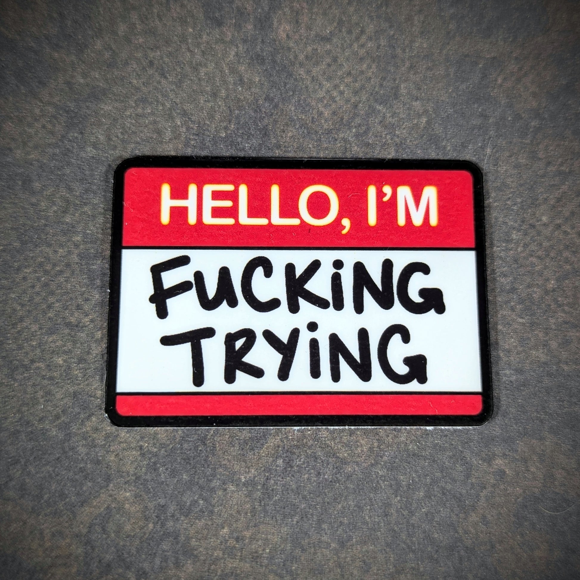 "Bold 'Hello, I'm F***ing Trying' sticker, perfect for humorously expressing determination and resilience. Ideal for adding a relatable touch to personal items like laptops, water bottles, or journals."