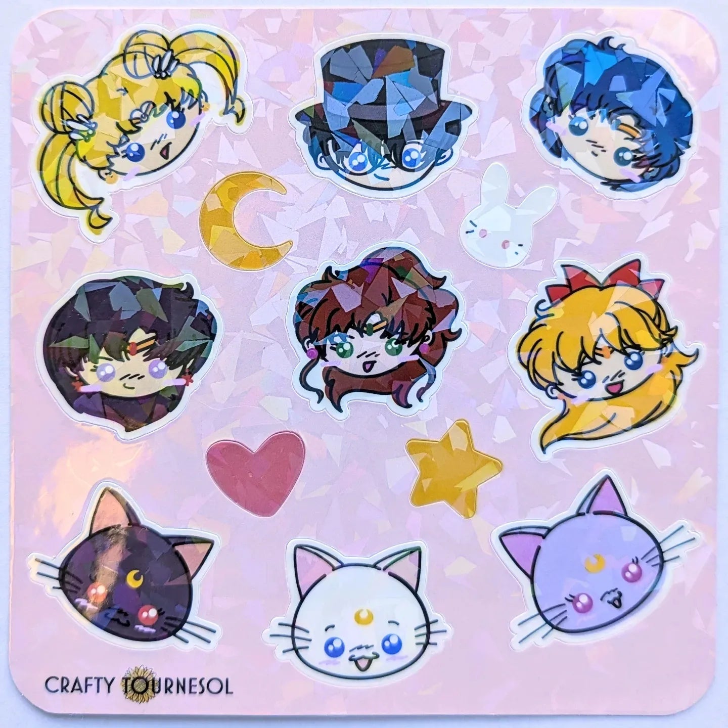 "Holographic sticker sheet featuring chibi characters inspired by Sailor Moon anime series, including moon-themed icons, cute cats, hearts, and stars. Perfect for decorating notebooks, laptops, and more."