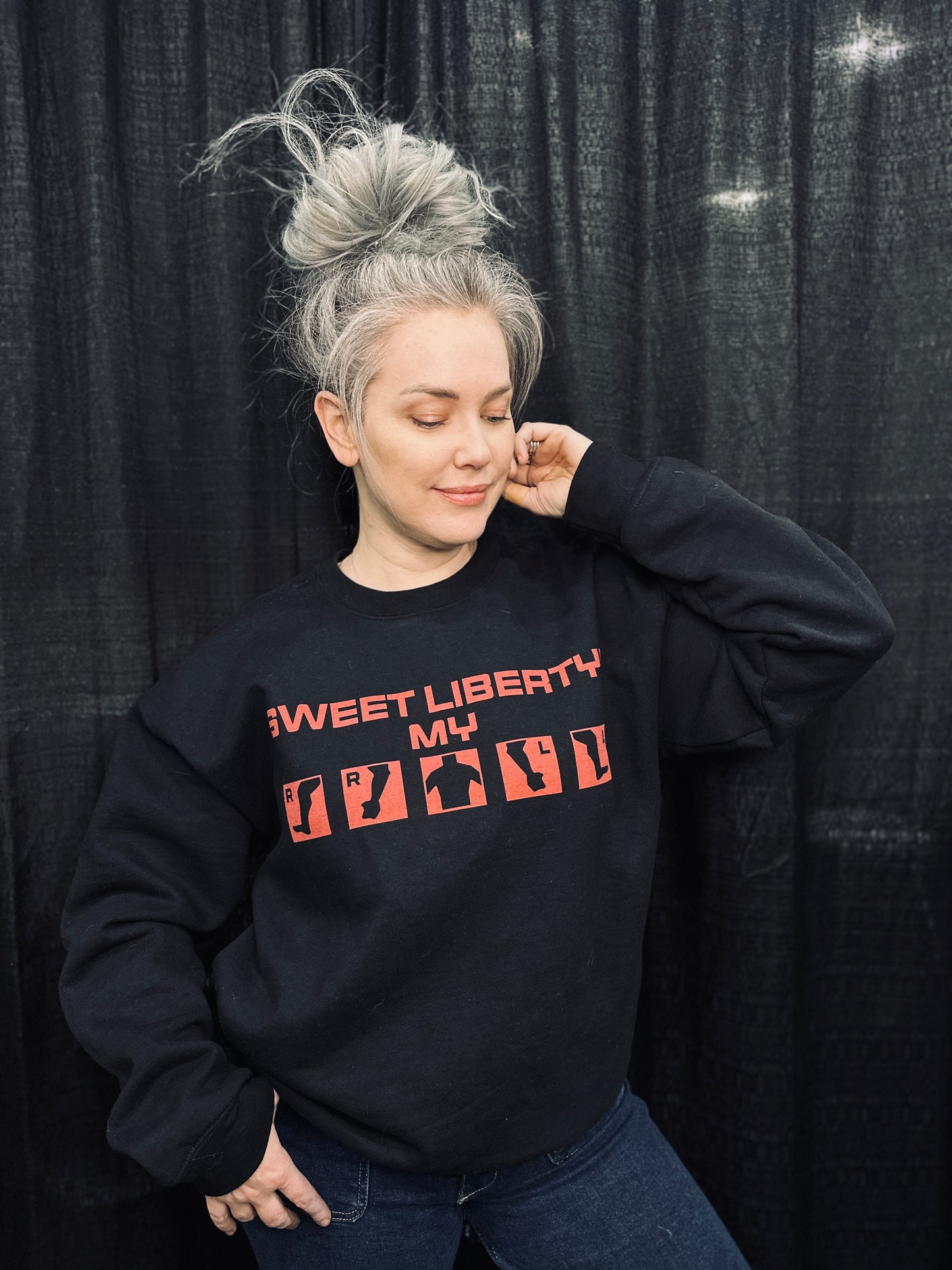Grey haired model wearing the "sweet liberty!" injury crew in size L. 