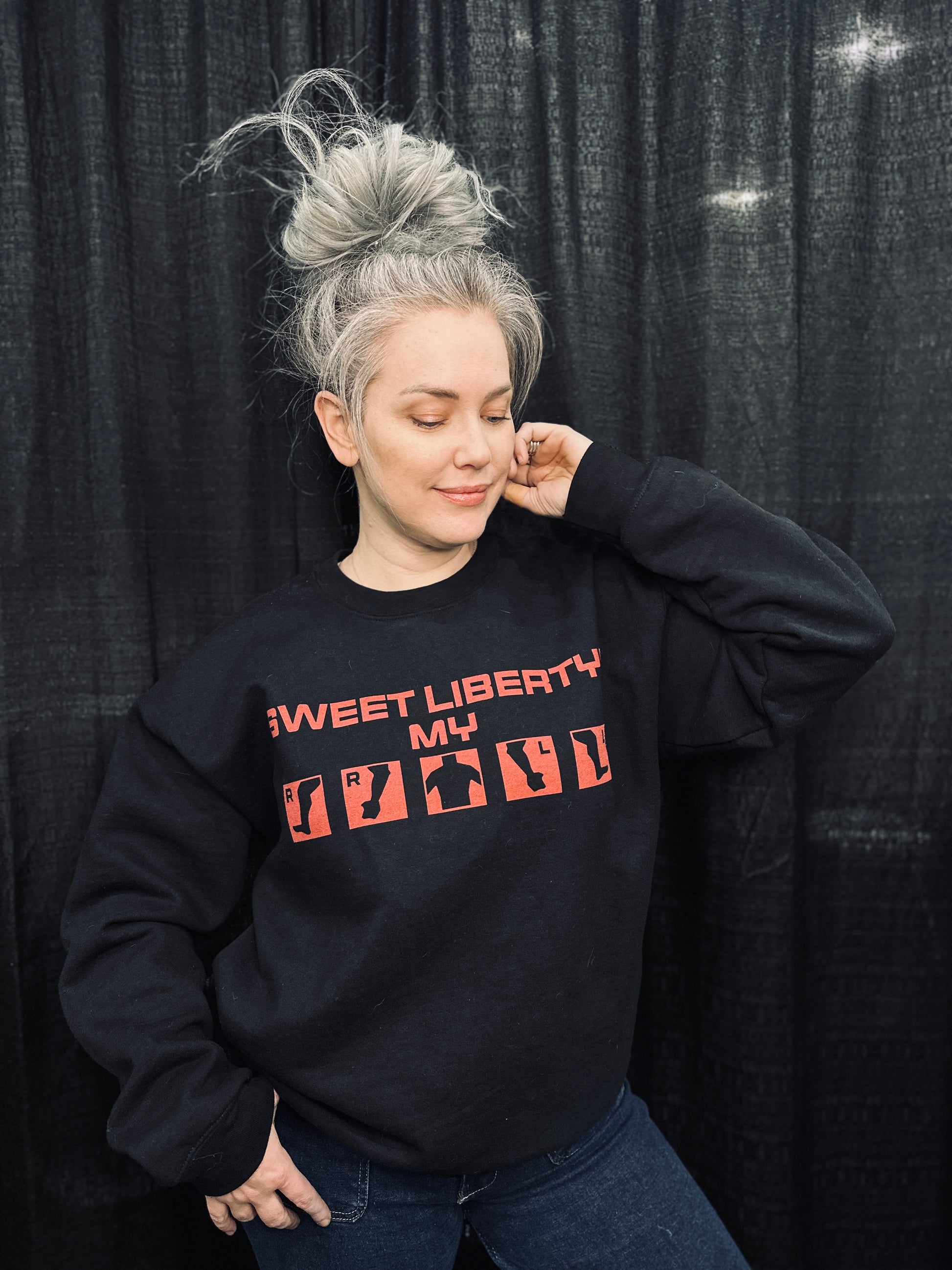 Grey haired model wearing the "sweet liberty!" injury crew in size L. 