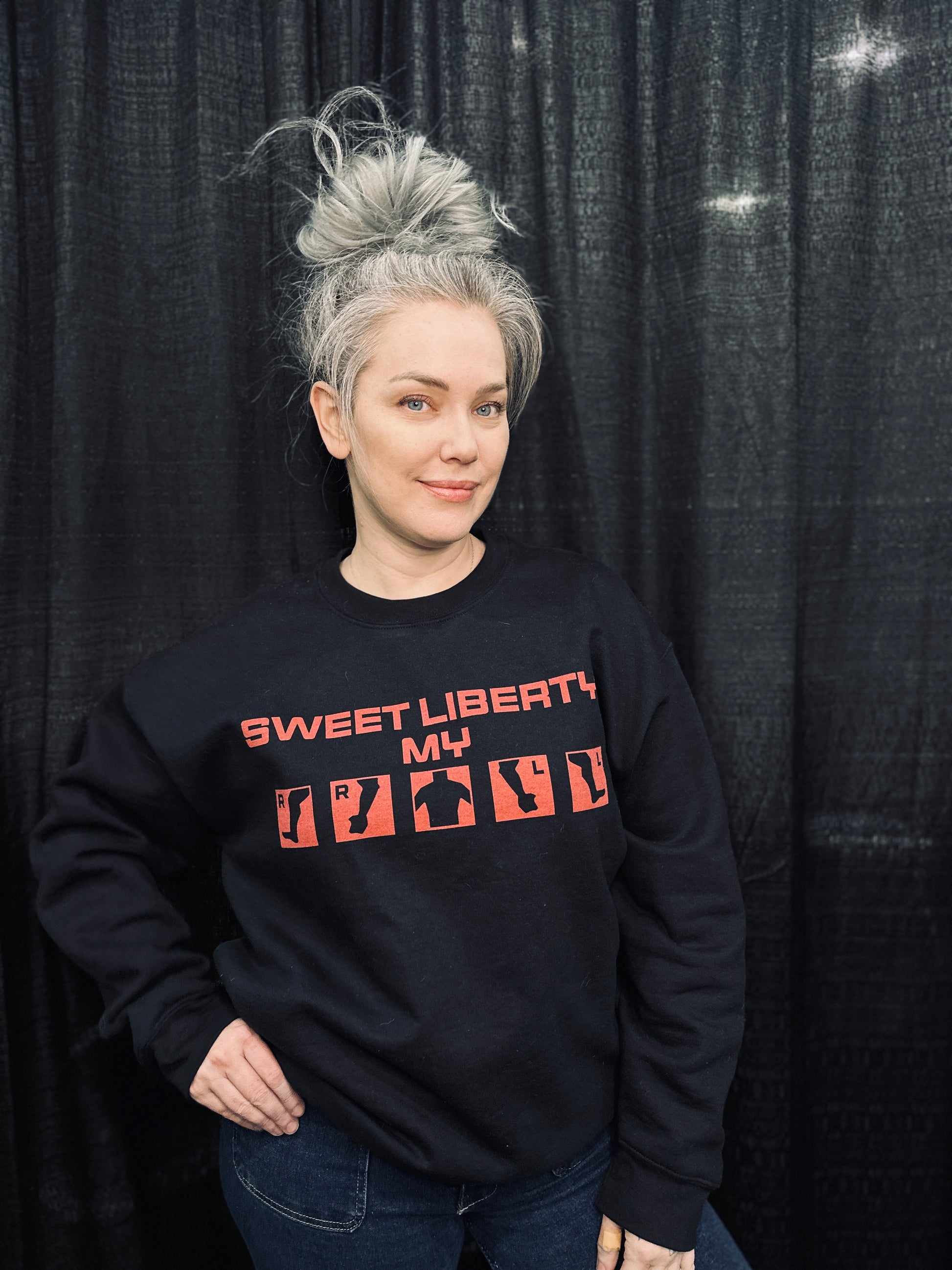 Grey haired model wearing the "sweet liberty!" injury crew in size L. 