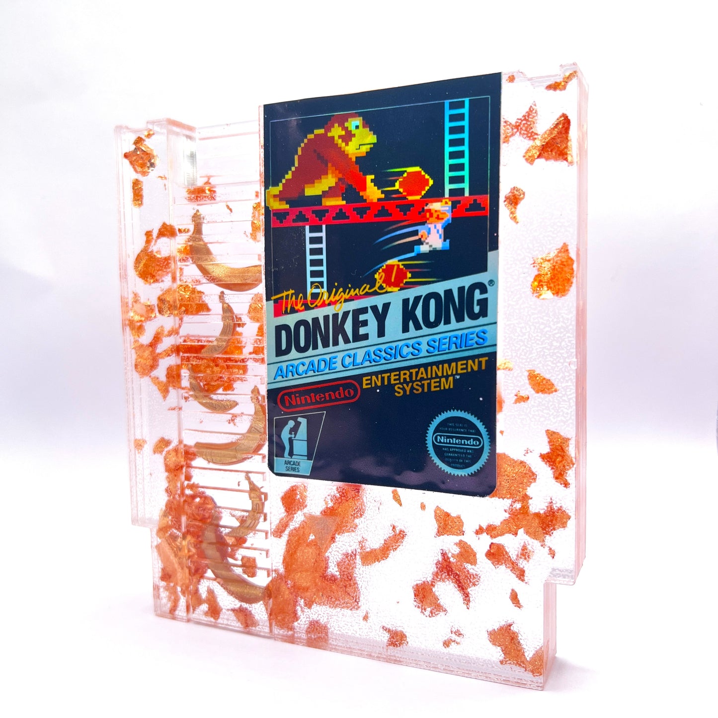 Handmade Donkey Kong NES cartridge art featuring gold bananas and copper leaf accents. Perfect retro gaming gift or unique game room decor.