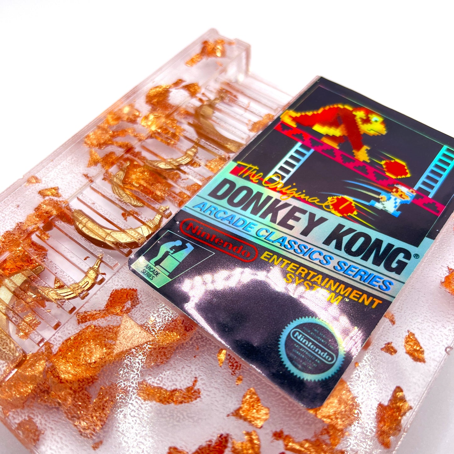 Handmade Donkey Kong NES cartridge art featuring gold bananas and copper leaf accents. Perfect retro gaming gift or unique game room decor.