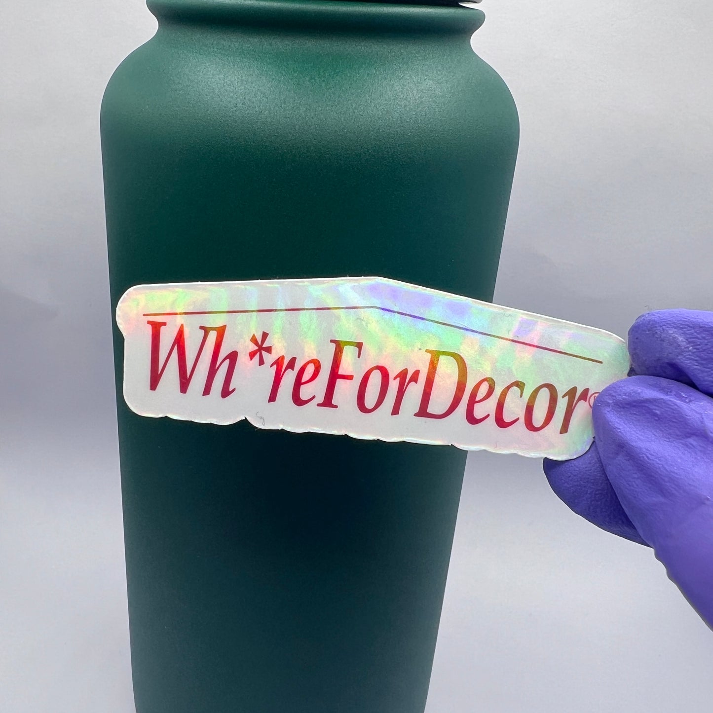 Holographic Wh*re for Decor vinyl sticker with a home goods-inspired design. Perfect for decor enthusiasts and anyone who loves a snarky touch.