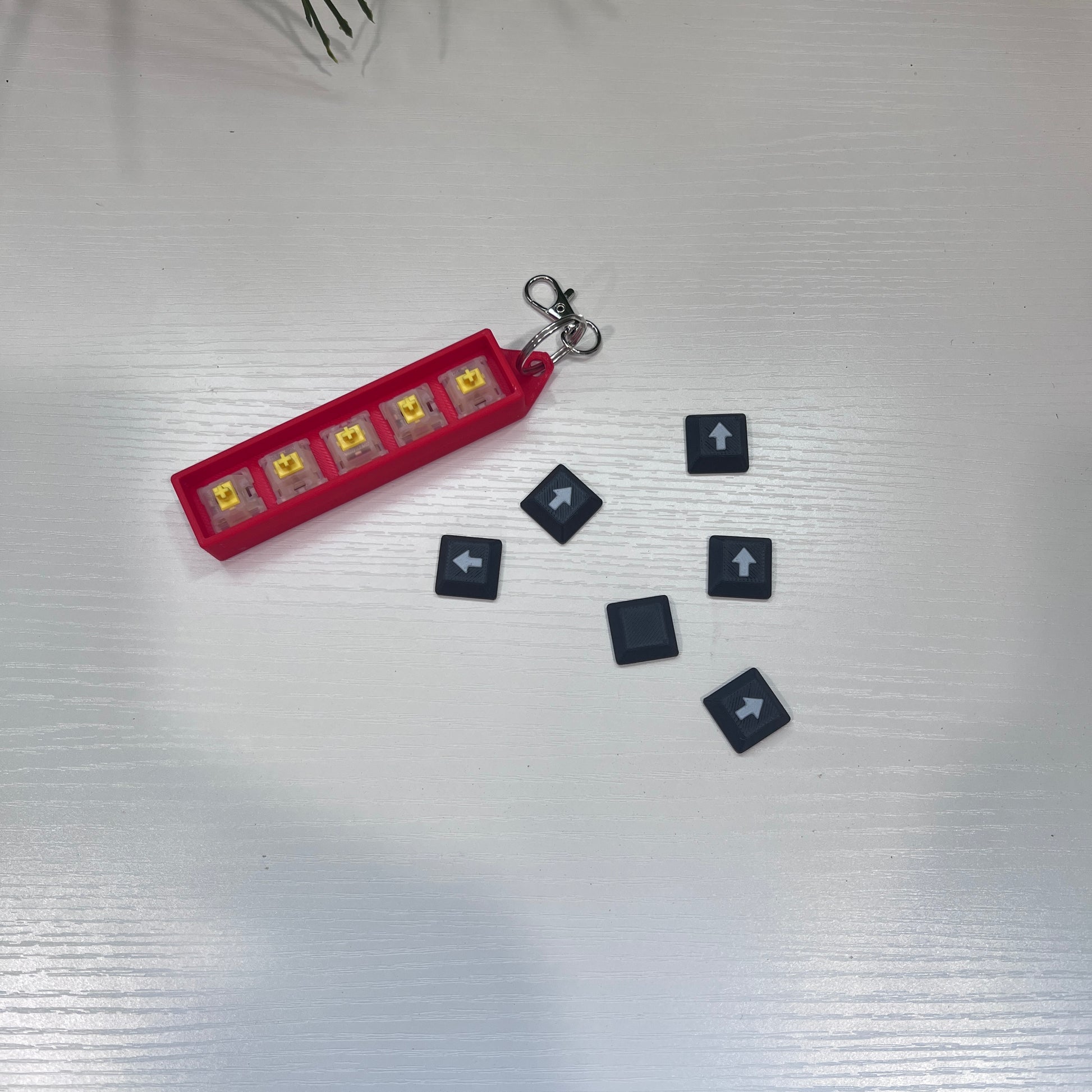 Helldivers 2-inspired keychain clicker featuring mechanical arrow keys. A perfect fidget toy for gamers, stress relief, and tactical clicking action.