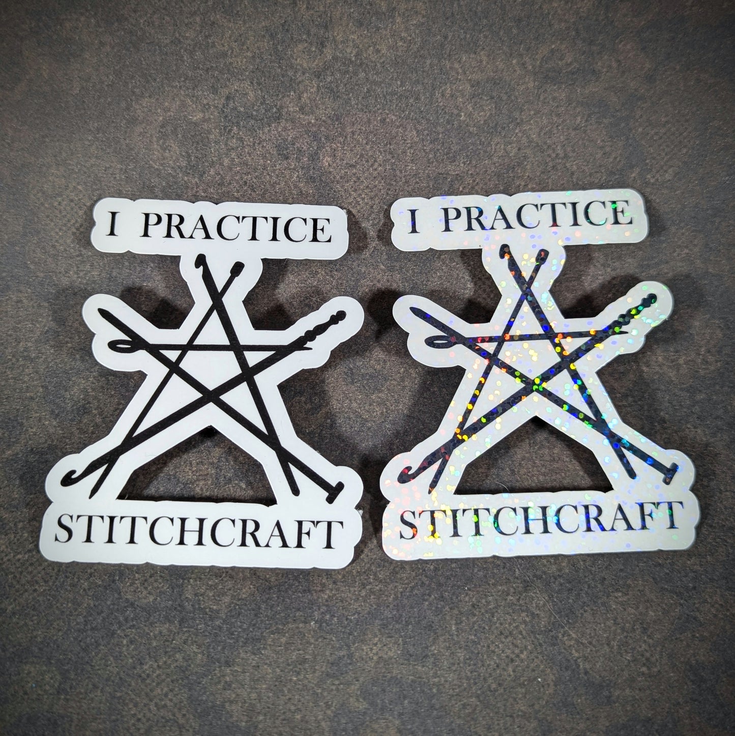 "Pair of 'I Practice Stitchcraft' stickers featuring knitting needles in a pentagram shape, one with holographic sparkle. Perfect for knitting enthusiasts with a sense of humor and love for crafty decor."