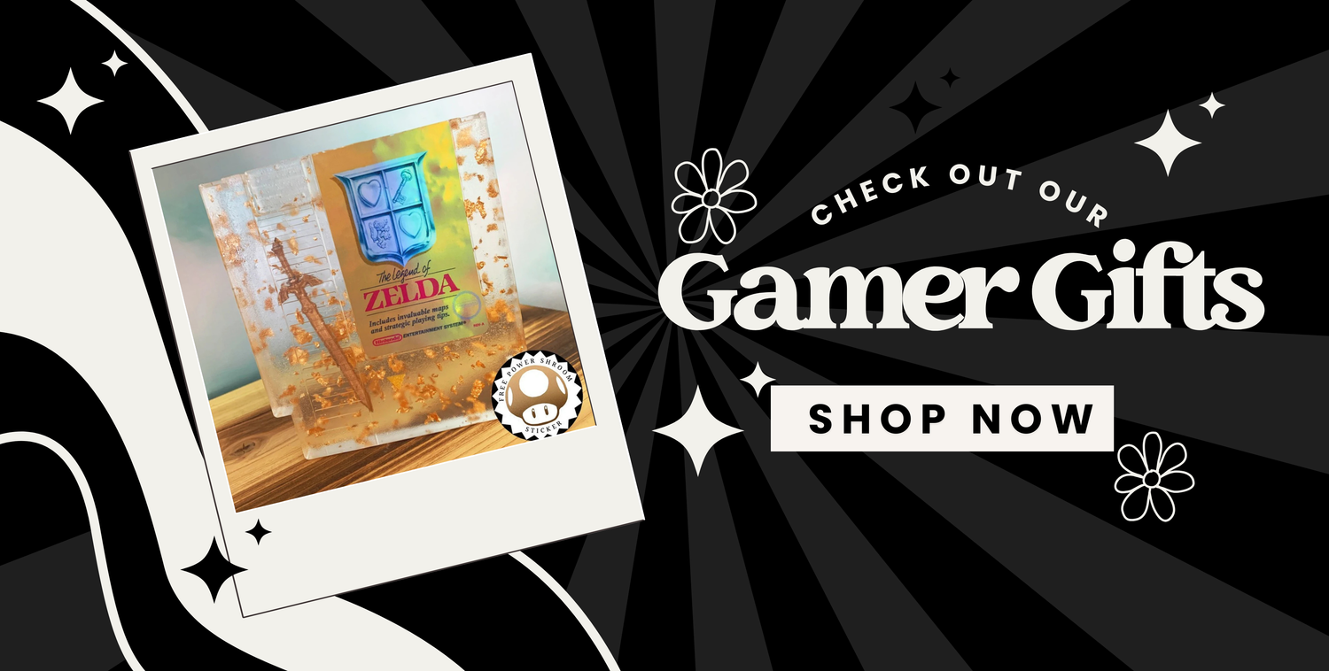 A banner that says "check out our gamer gifts" with an image of a gold Legend of Zelda NES cartridge art display