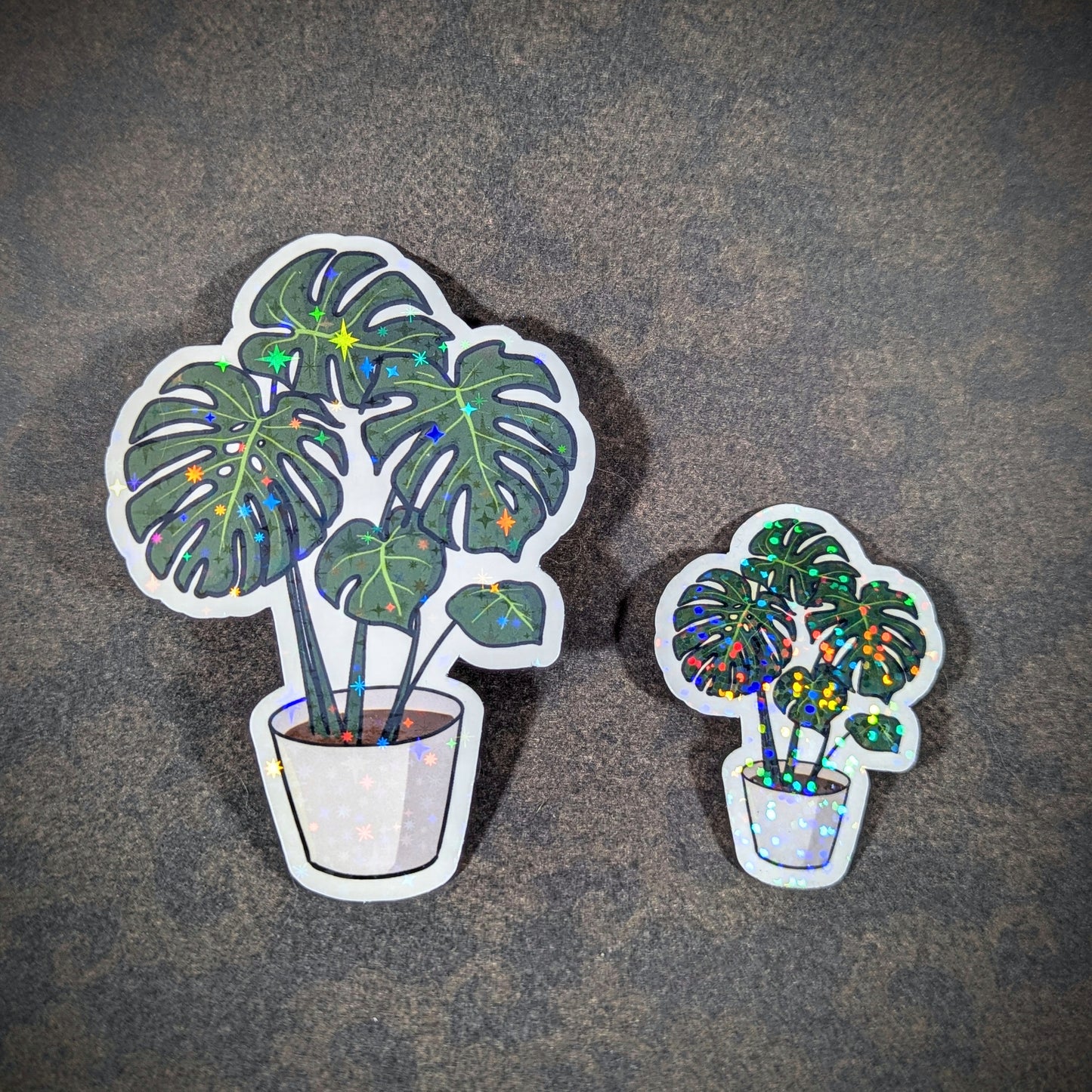 "Holographic monstera plant stickers in white pots, featuring large, vibrant leaves with sparkling accents. Ideal for plant lovers and adding a touch of botanical flair to laptops, journals, or decor."