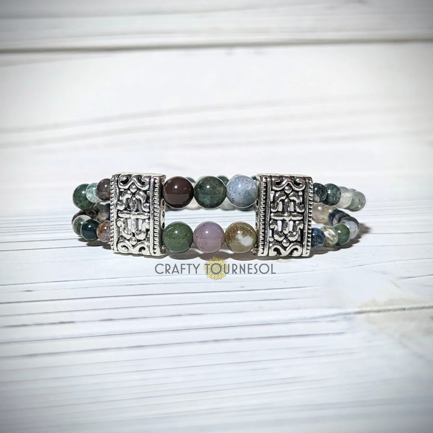 "Elegant agate bracelet with ornate silver accents, showcasing earthy green and pink gemstones. Perfect for nature-inspired jewelry lovers seeking a sophisticated accessory that adds charm to any outfit."