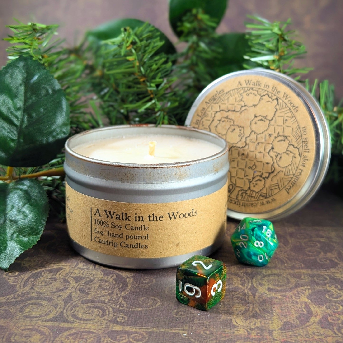 "A Walk in the Woods 6 oz soy wax candle tin by Cantrip Candles, with scents of pine and sandalwood, staged with RPG dice and forest-inspired decor, perfect for creating a fresh, woodland ambiance for gamers and nature enthusiasts."