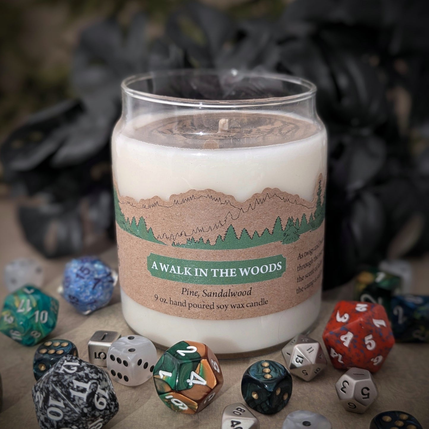 "A Walk in the Woods candle by Cantrip Candles, hand-poured 9 oz soy wax, pine and sandalwood scent. Staged with RPG dice. Perfect for nature lovers and cozy ambiance seekers."