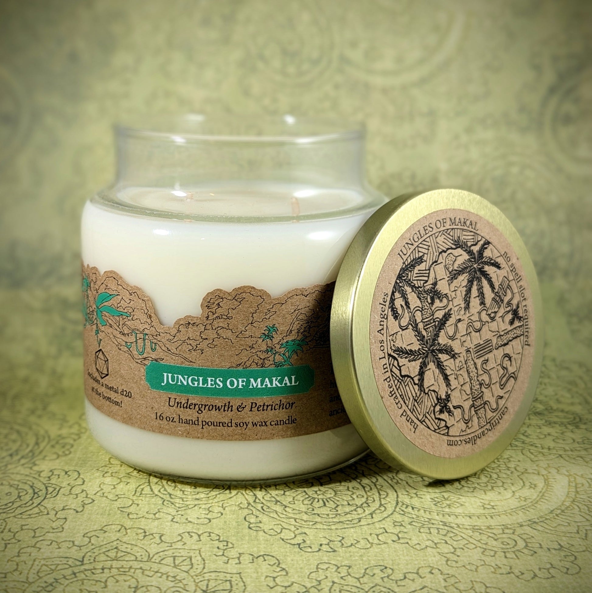 "Jungles of Makal candle by Cantrip Candles, 16 oz soy wax with undergrowth and petrichor scent. Features a jungle-themed map lid, perfect for adventurers and nature lovers seeking an immersive aroma experience."