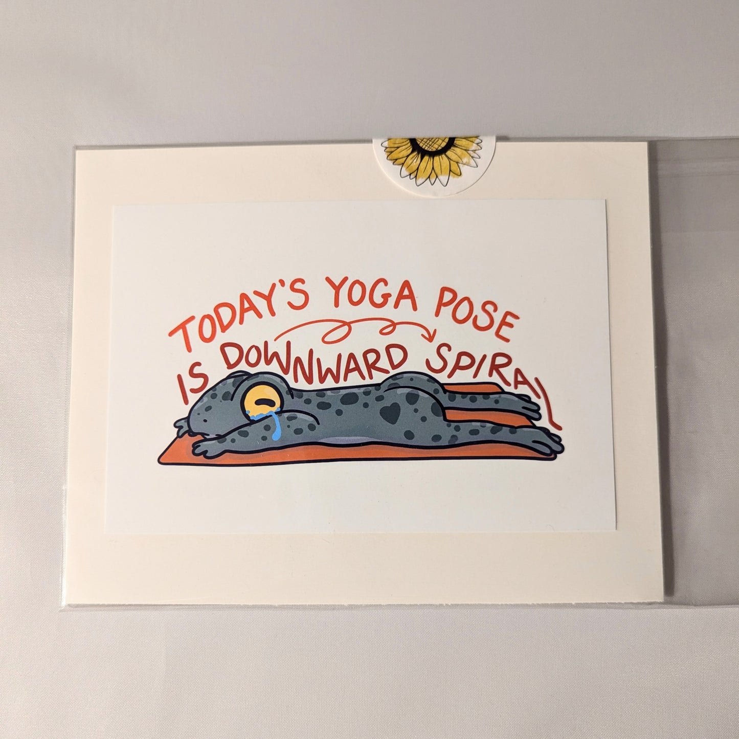 "Humorous 'Today's Yoga Pose is Downward Spiral' art print featuring a tired frog illustration. Great gift for yoga enthusiasts, mental health awareness, or adding playful decor to home, office, or studio."