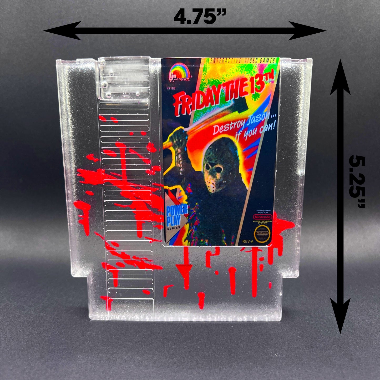 Friday the 13th NES cartridge-inspired collectible with blood splatter design featuring Jason Voorhees. Perfect for retro horror fans and gaming enthusiasts who love unique, creepy decor.