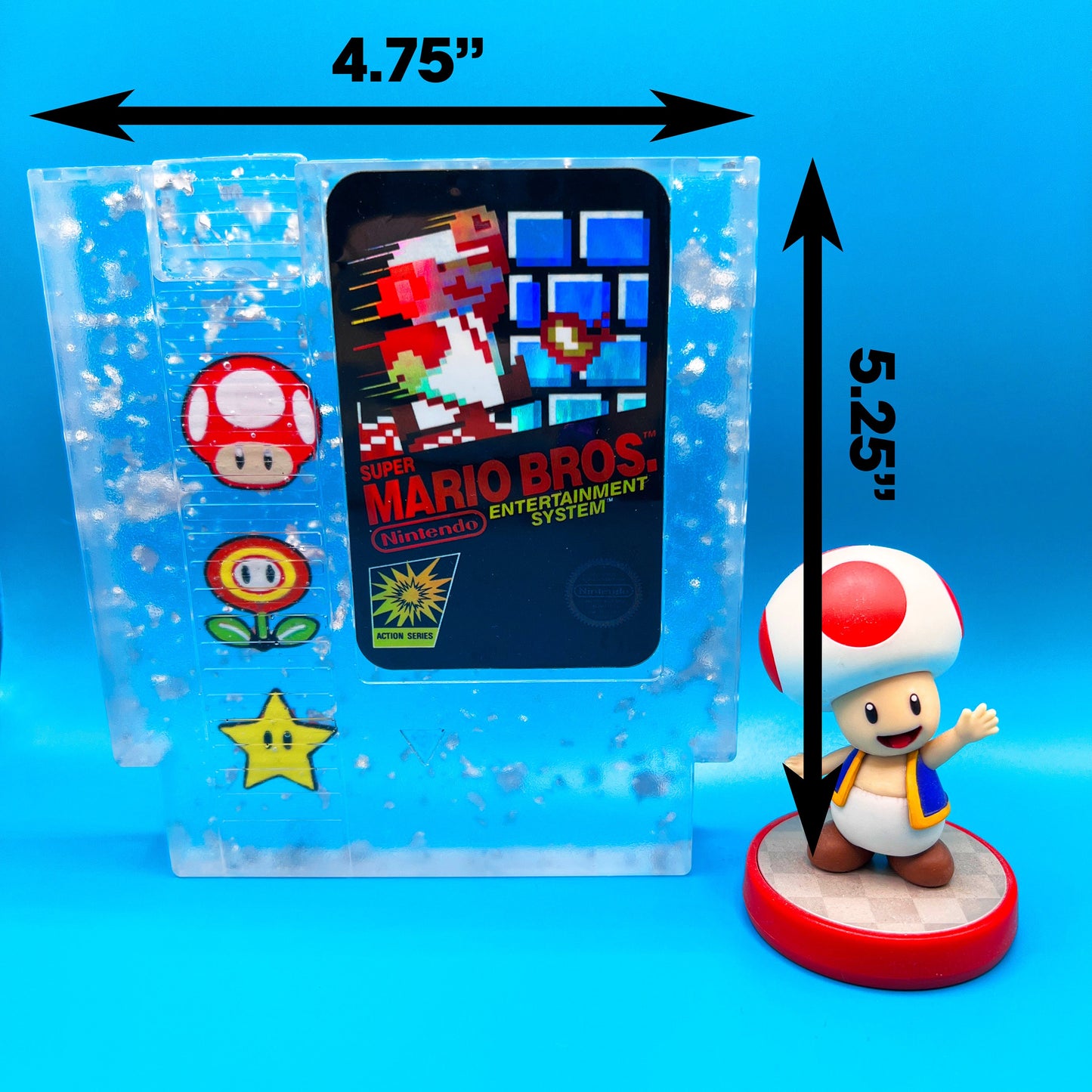 Handmade resin art featuring a retro Super Mario Bros NES cartridge with classic icons like the mushroom, fire flower, and star. Perfect for gamers, collectors, or unique home decor to add a nostalgic touch to any space.