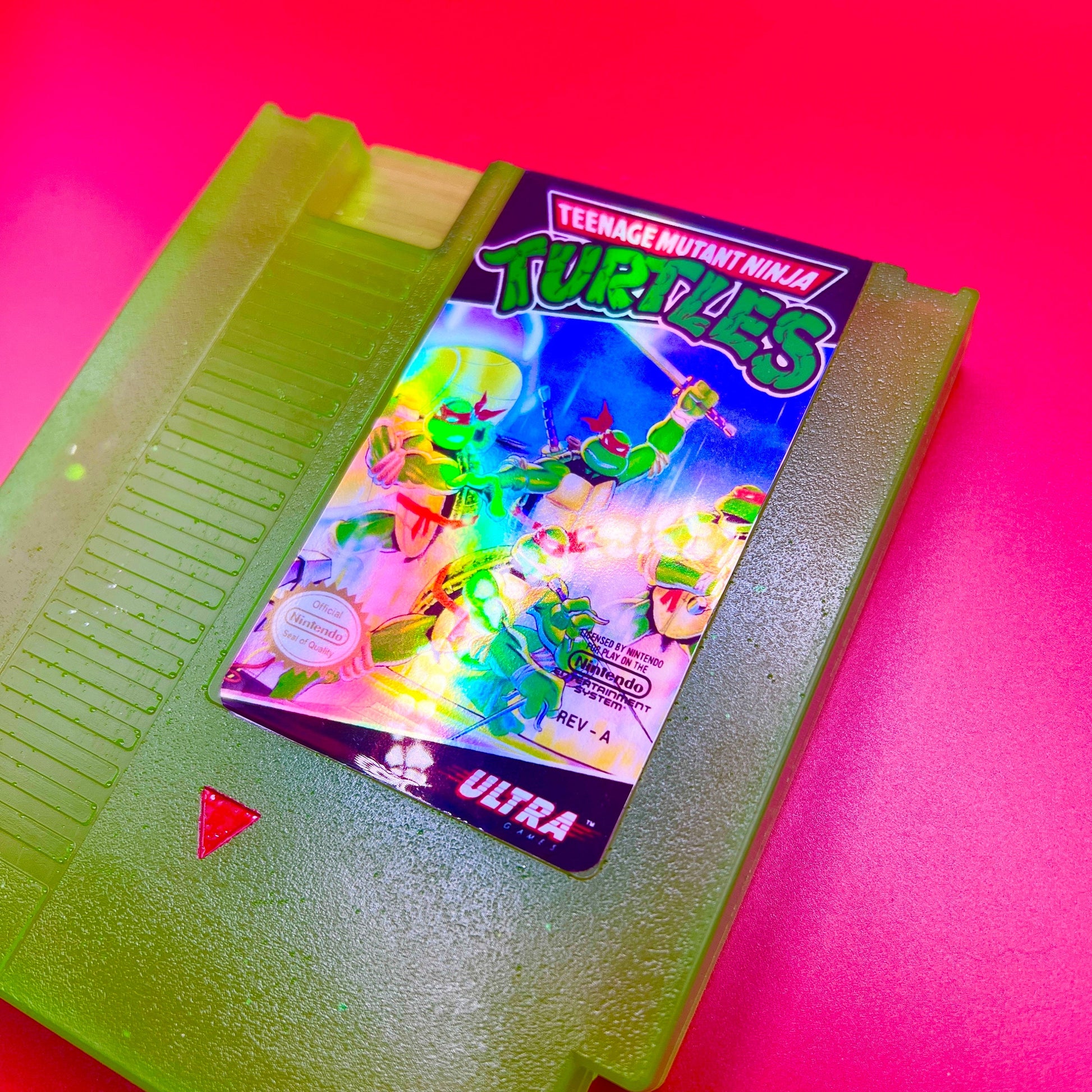 This glowing Teenage Mutant Ninja Turtles NES cartridge is a retro, geeky collectible display. Handmade with glowing elements, it's perfect for nostalgic gamers and TMNT fans as a unique gift or decor.