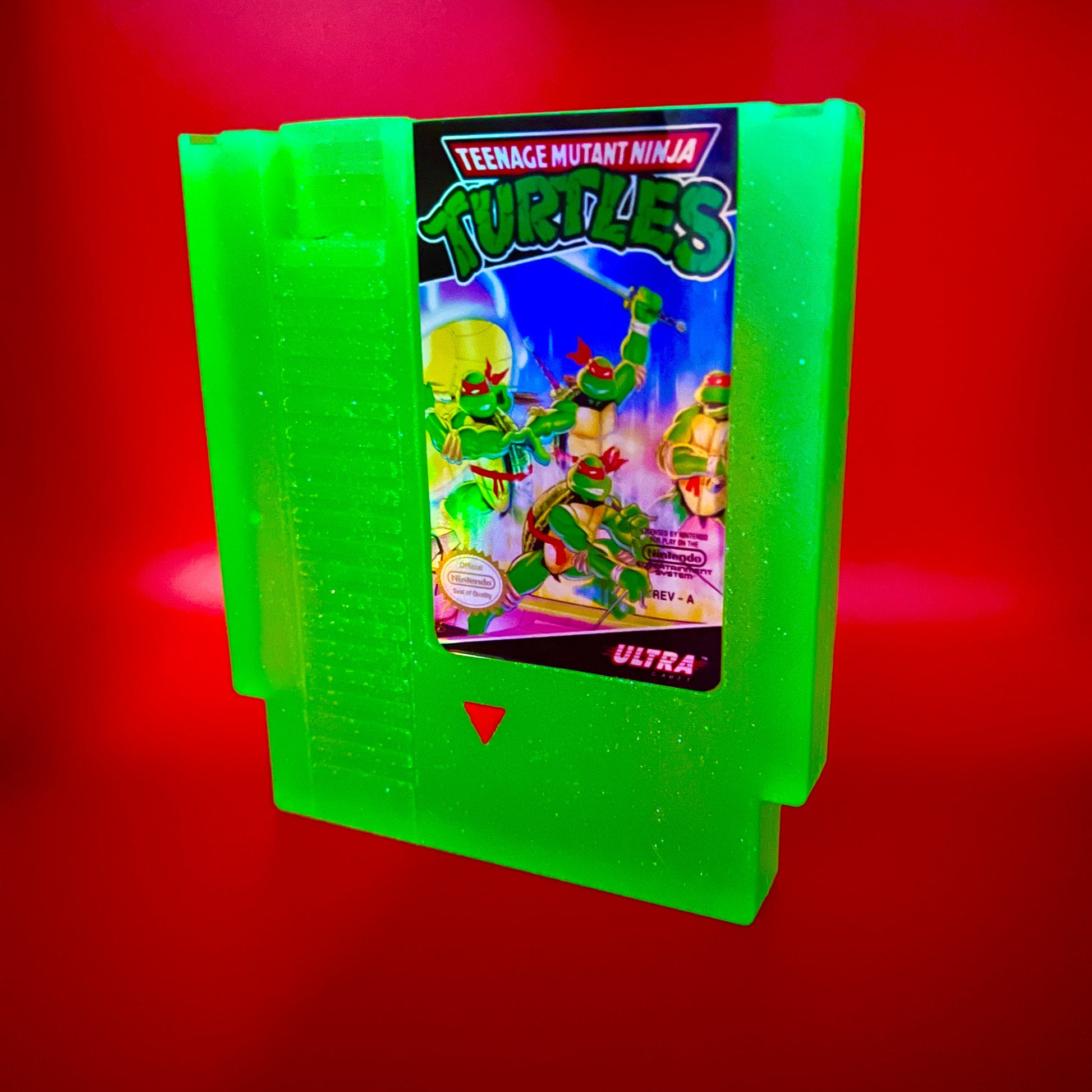 This glowing Teenage Mutant Ninja Turtles NES cartridge is a retro, geeky collectible display. Handmade with glowing elements, it's perfect for nostalgic gamers and TMNT fans as a unique gift or decor.