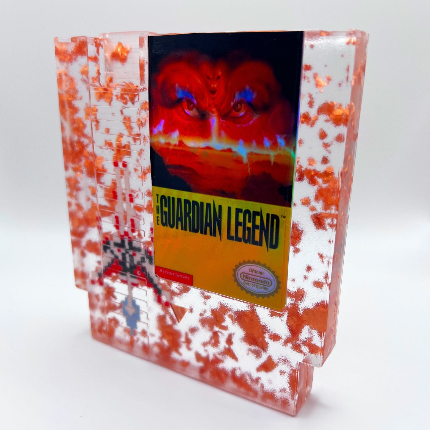 Handcrafted The Guardian Legend custom NES cartridge featuring vibrant orange and holographic elements. This retro gaming art piece adds a unique flair to any collection.