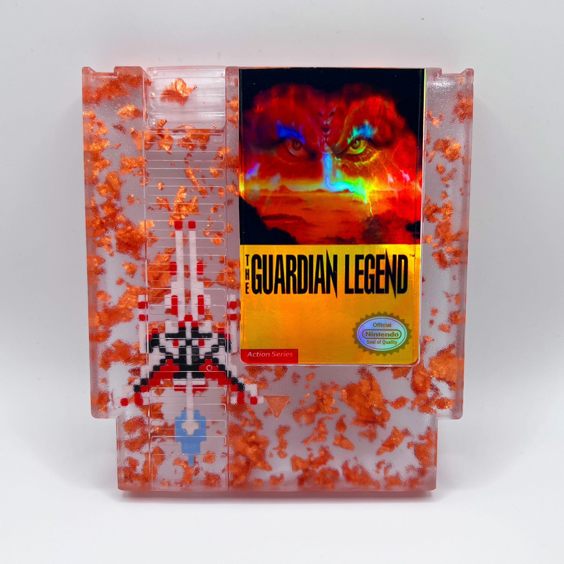 Handcrafted The Guardian Legend custom NES cartridge featuring vibrant orange and holographic elements. This retro gaming art piece adds a unique flair to any collection.