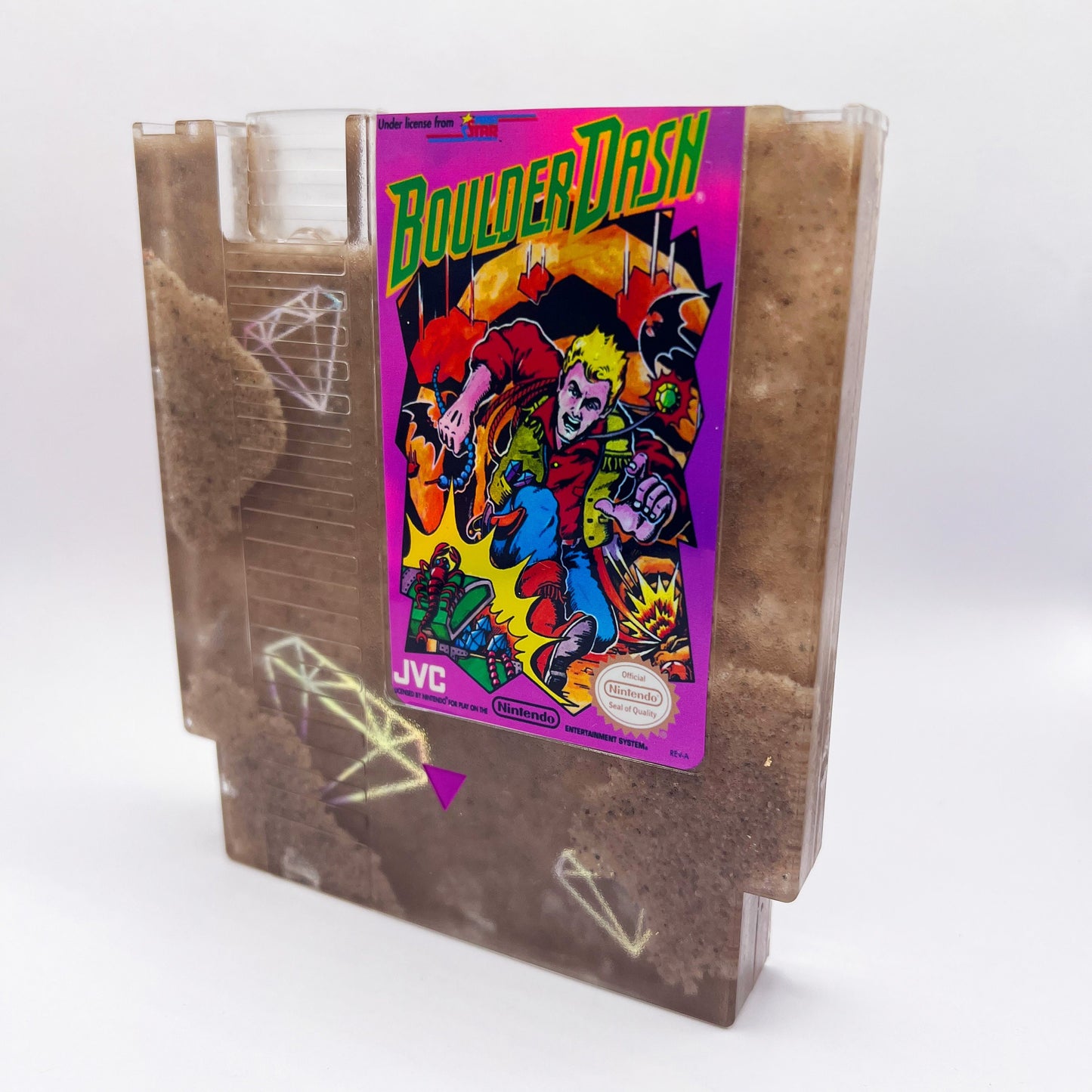 Handmade Boulder Dash NES cartridge art featuring intricate sand and diamond designs on a transparent casing. A perfect gift for retro gaming enthusiasts.