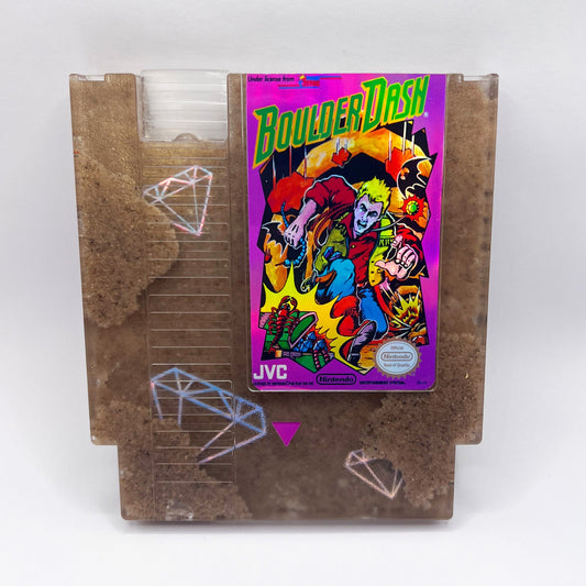 Handmade Boulder Dash NES cartridge art featuring intricate sand and diamond designs on a transparent casing. A perfect gift for retro gaming enthusiasts.