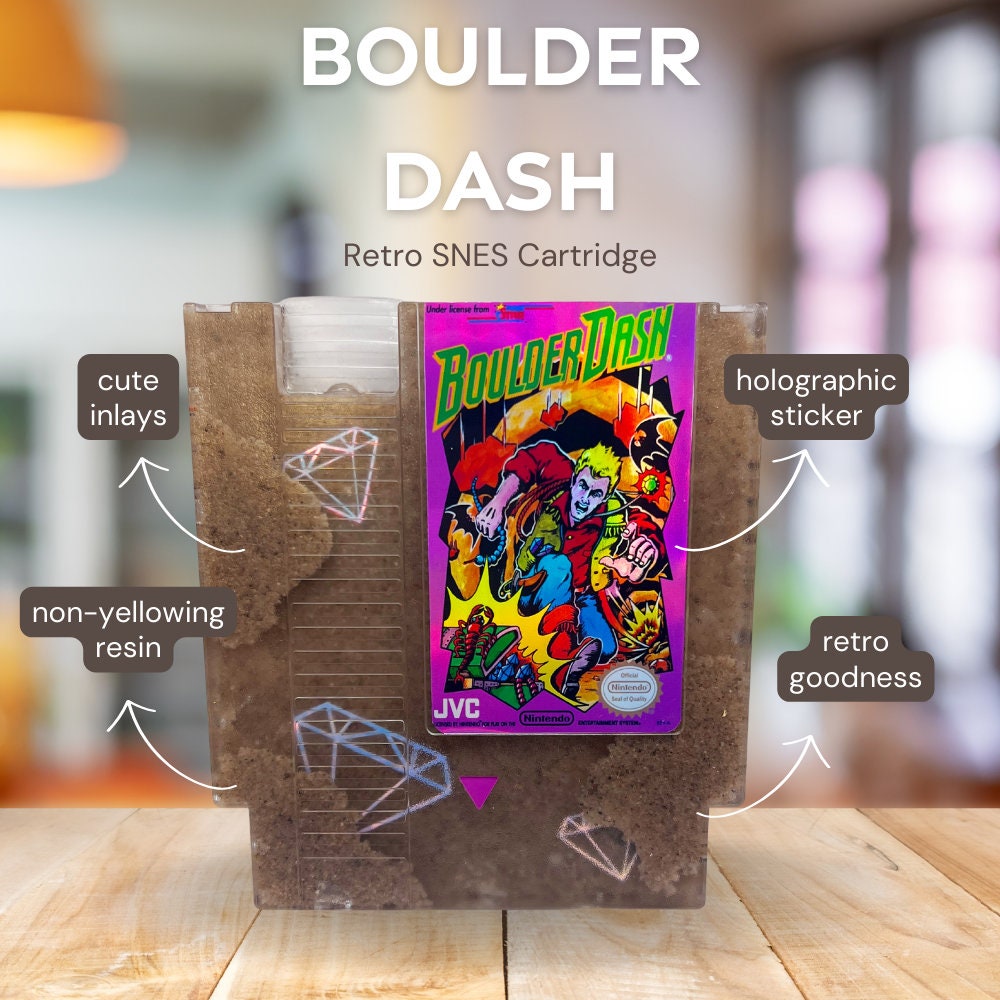 Handmade Boulder Dash NES cartridge art featuring intricate sand and diamond designs on a transparent casing. A perfect gift for retro gaming enthusiasts.