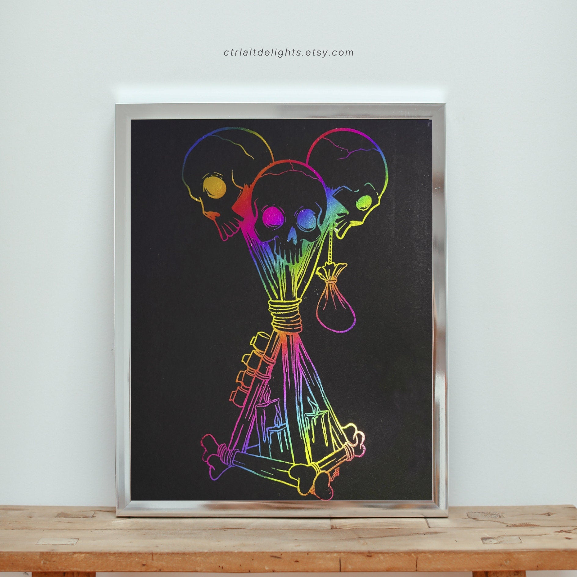 Hand-foiled Dead by Daylight totem artwork featuring three rainbow-colored skulls tied with candles and bones on black cardstock. This custom, vibrant totem design brings a unique twist to iconic game imagery, perfect for horror and gaming fans.