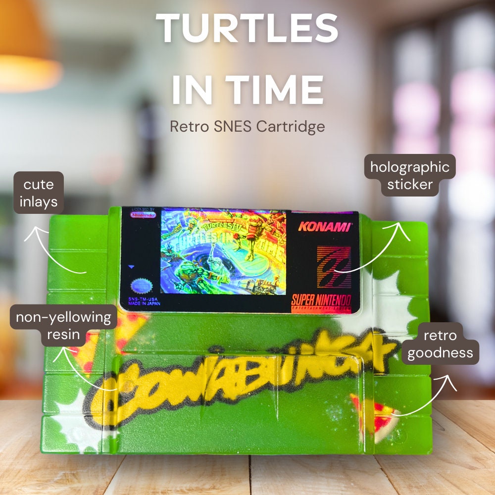 Handmade resin replica of the classic SNES game Turtles in Time. Vibrant green design with graffiti-style elements and retro cartridge art. Perfect for gamers, collectors, or as a unique shelf display for TMNT fans