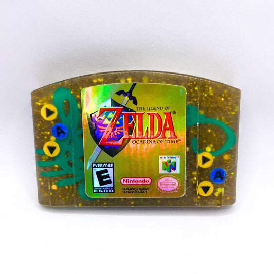 This handmade Zelda Ocarina of Time resin cartridge features vibrant custom art, adding a nostalgic touch for retro gaming fans. Ideal as a unique gift or display piece for collectors and gamers alike. 