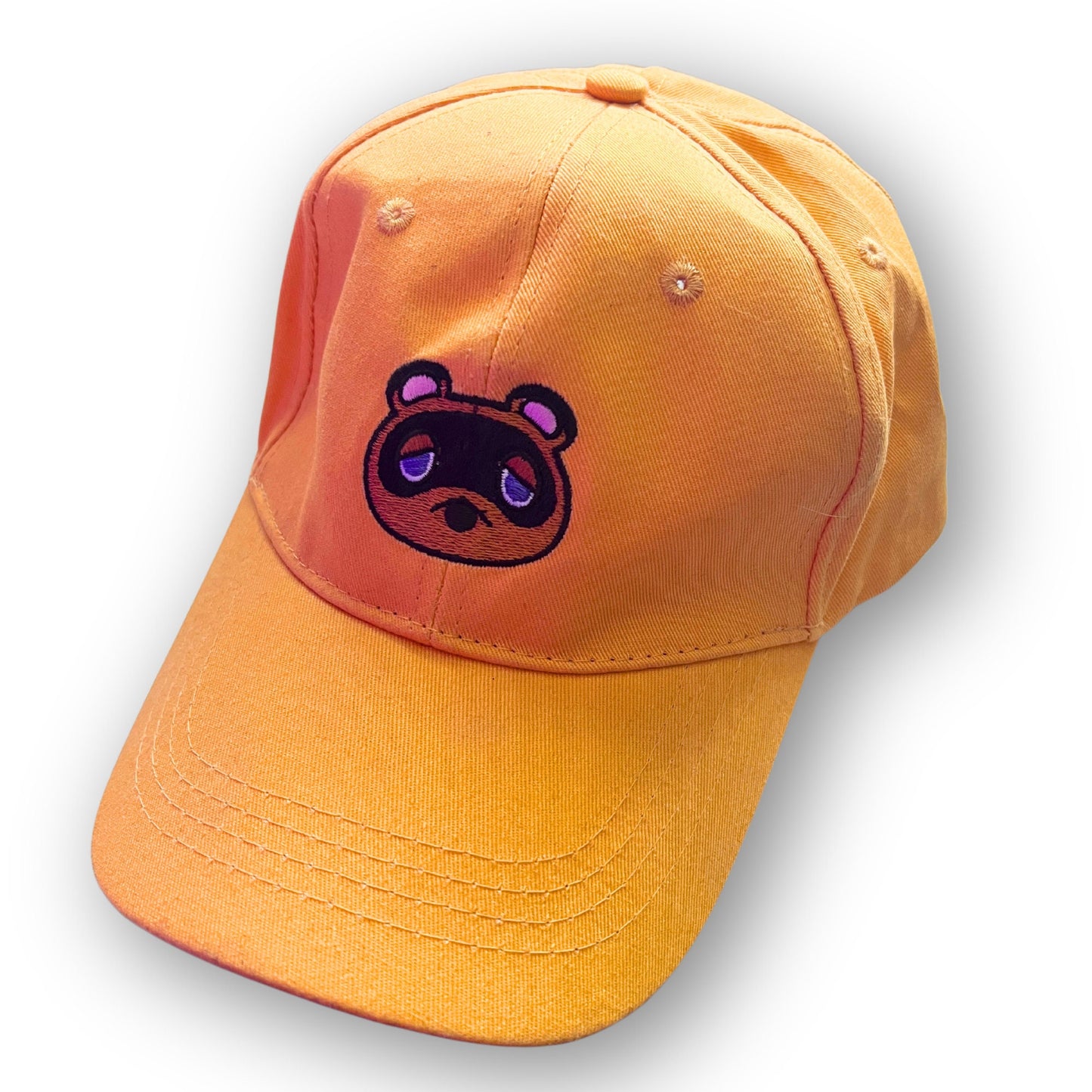 Tom Nook inspired embroidered dad hat featuring the iconic character from Animal Crossing, perfect for gamers. The orange cap with detailed stitching makes a fun accessory for fans of the beloved series.