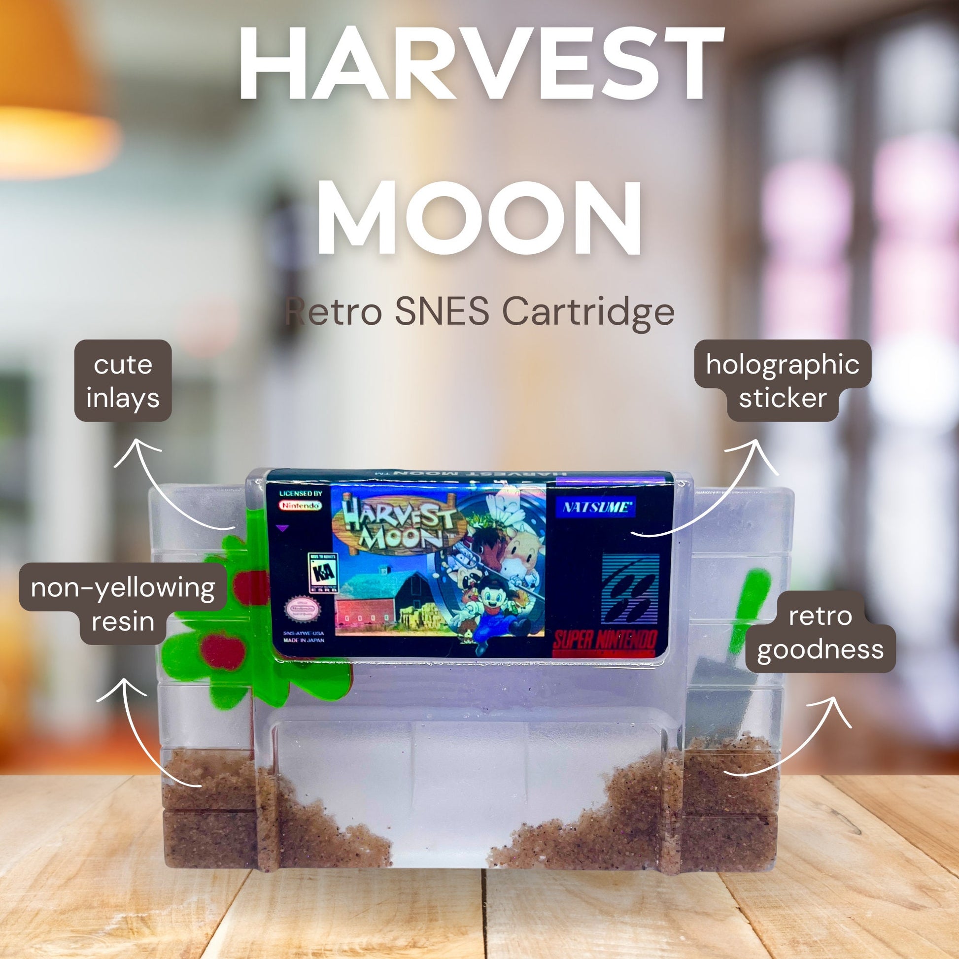 Custom resin art featuring a clear Super Nintendo game cartridge of Harvest Moon filled with decorative sand and tiny plant accents. Perfect as a nostalgic, geek-inspired desk or shelf display for retro gaming enthusiasts.