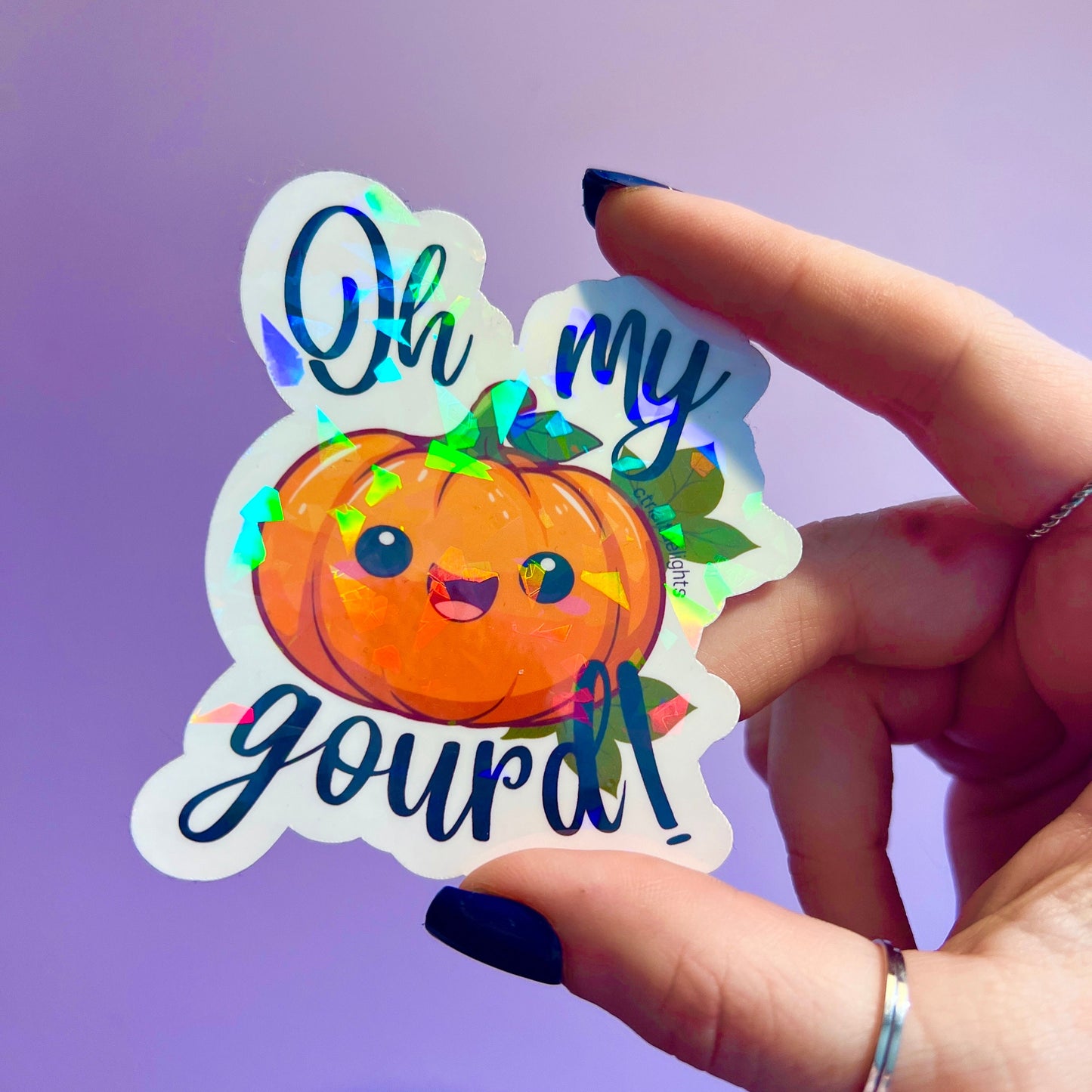 holographic Oh My Gourd! pumpkin sticker. The cute kawaii design features a smiling pumpkin with vibrant fall colors and a glossy finish, perfect for autumn or Halloween decor