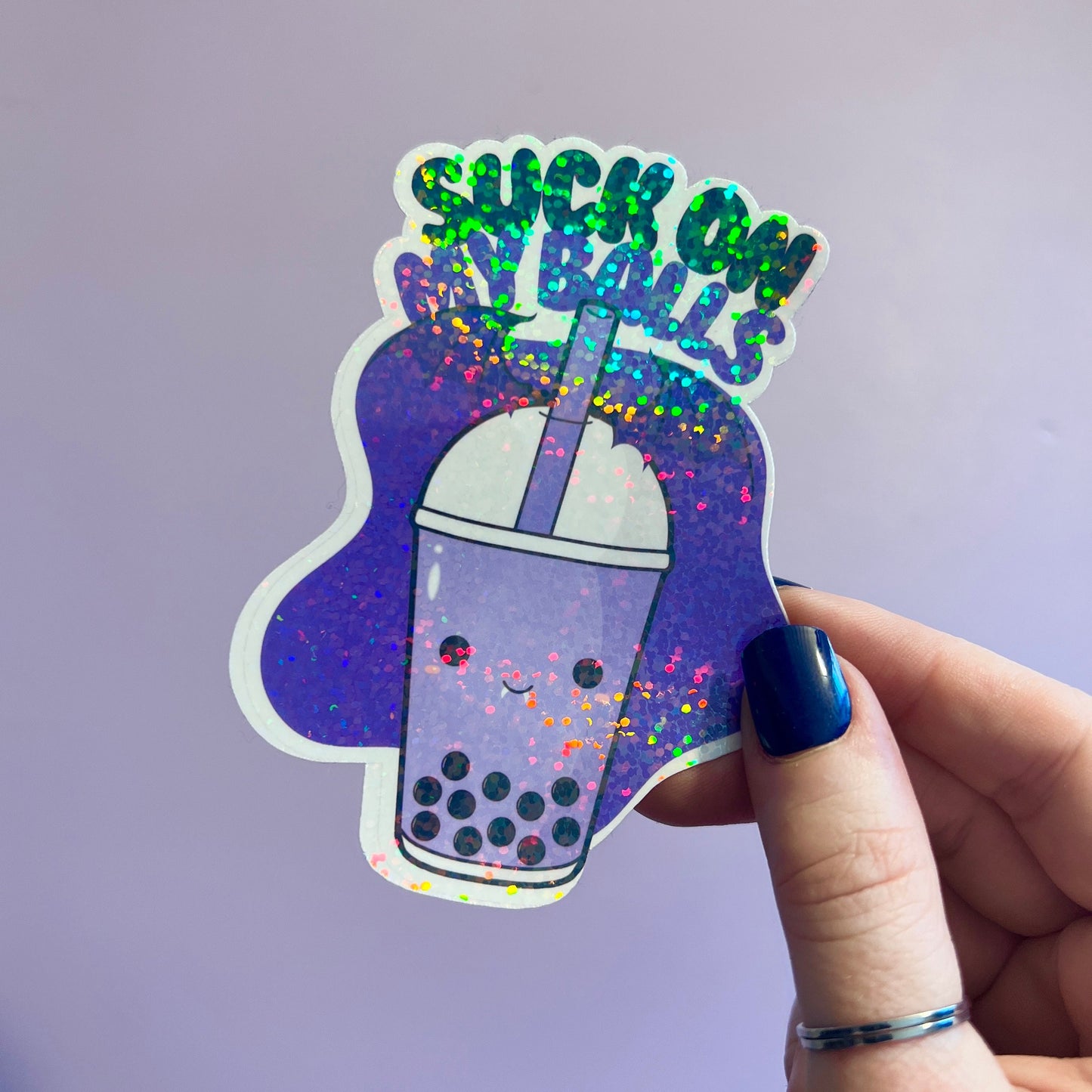 Holographic boba tea sticker with a cute bubble tea cup and the playful phrase Suck on My Balls in bold text. Perfect for decorating water bottles, laptops, and journals, this sassy and fun vinyl decal adds a quirky touch to your accessories.