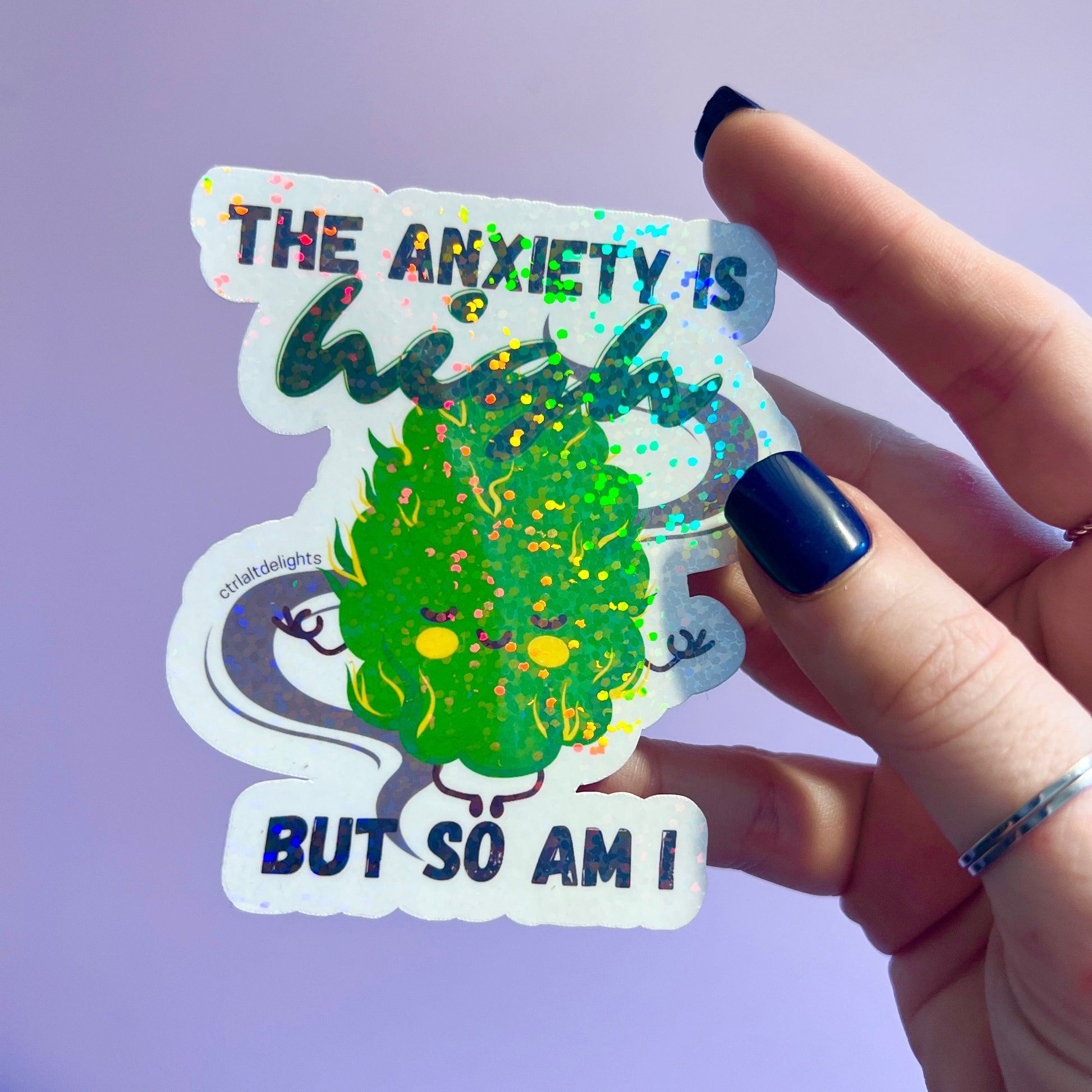 Holographic sticker featuring a cute cannabis bud meditating with the phrase 'The Anxiety is High But So Am I.' A perfect gift for stoners or anyone who enjoys playful anxiety relief humor.