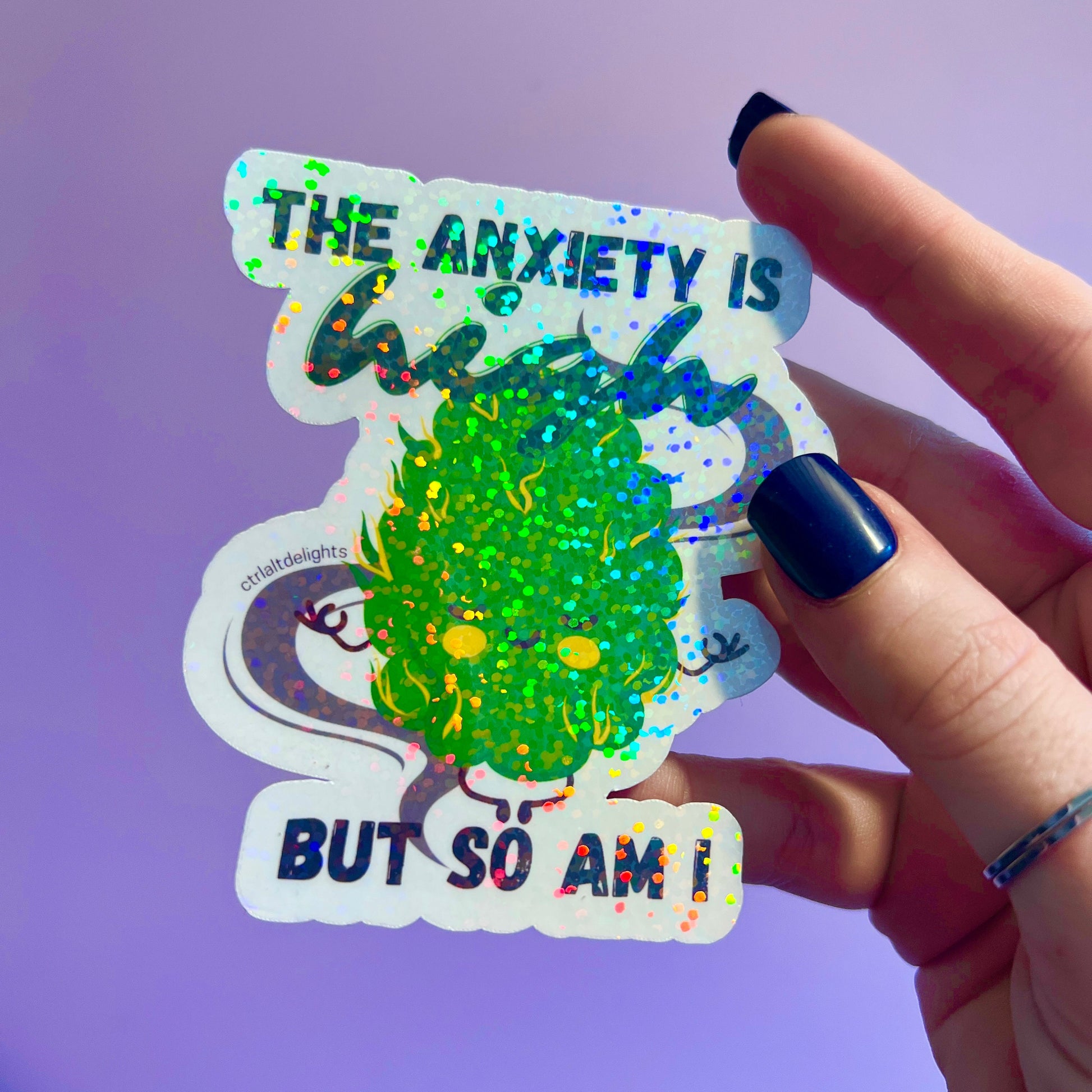 Holographic sticker featuring a cute cannabis bud meditating with the phrase 'The Anxiety is High But So Am I.' A perfect gift for stoners or anyone who enjoys playful anxiety relief humor.