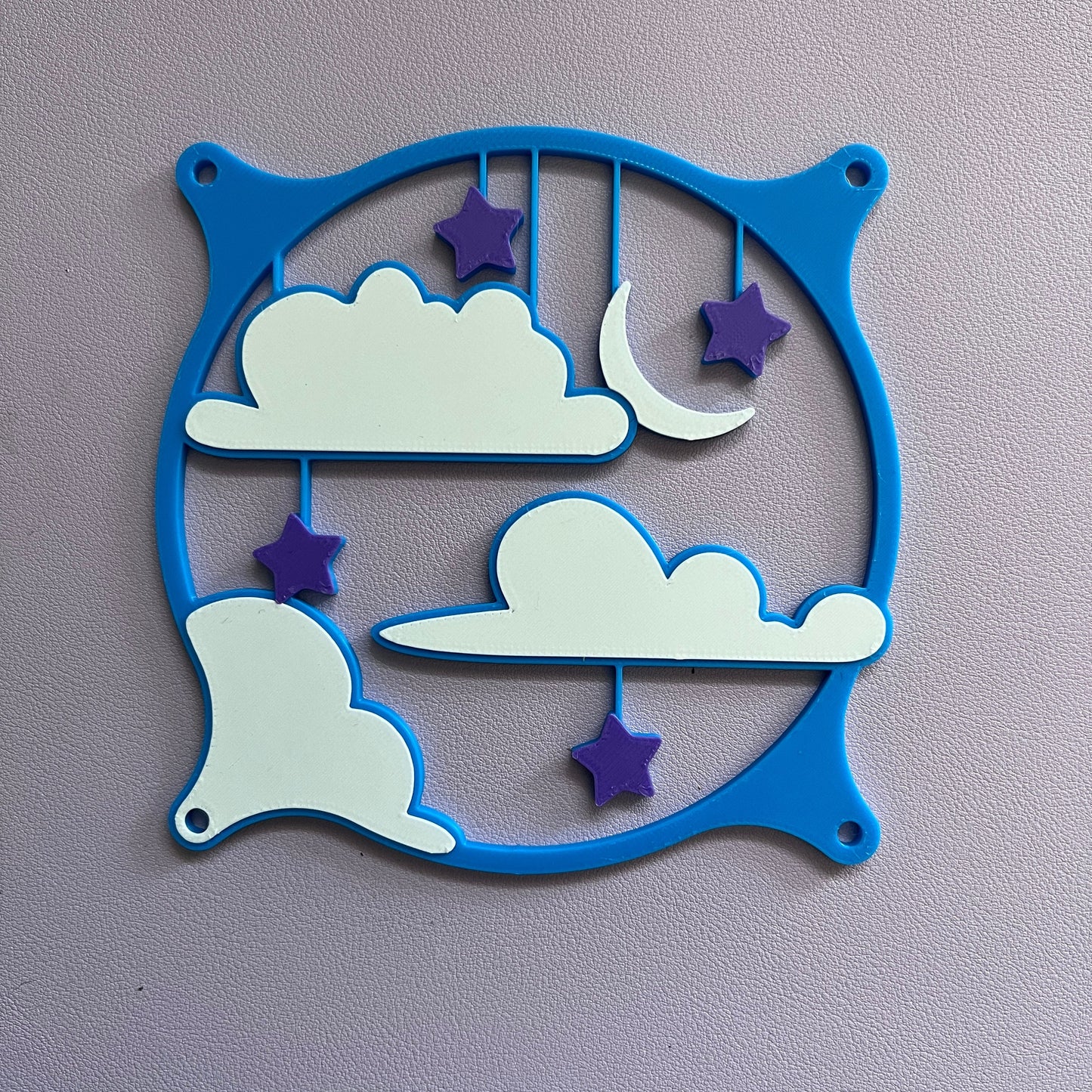 This whimsical 3D printed PC fan grille cover features pastel clouds, stars, and a crescent moon, adding a playful and cute touch to your gaming setup or workspace with a soft, kawaii style.