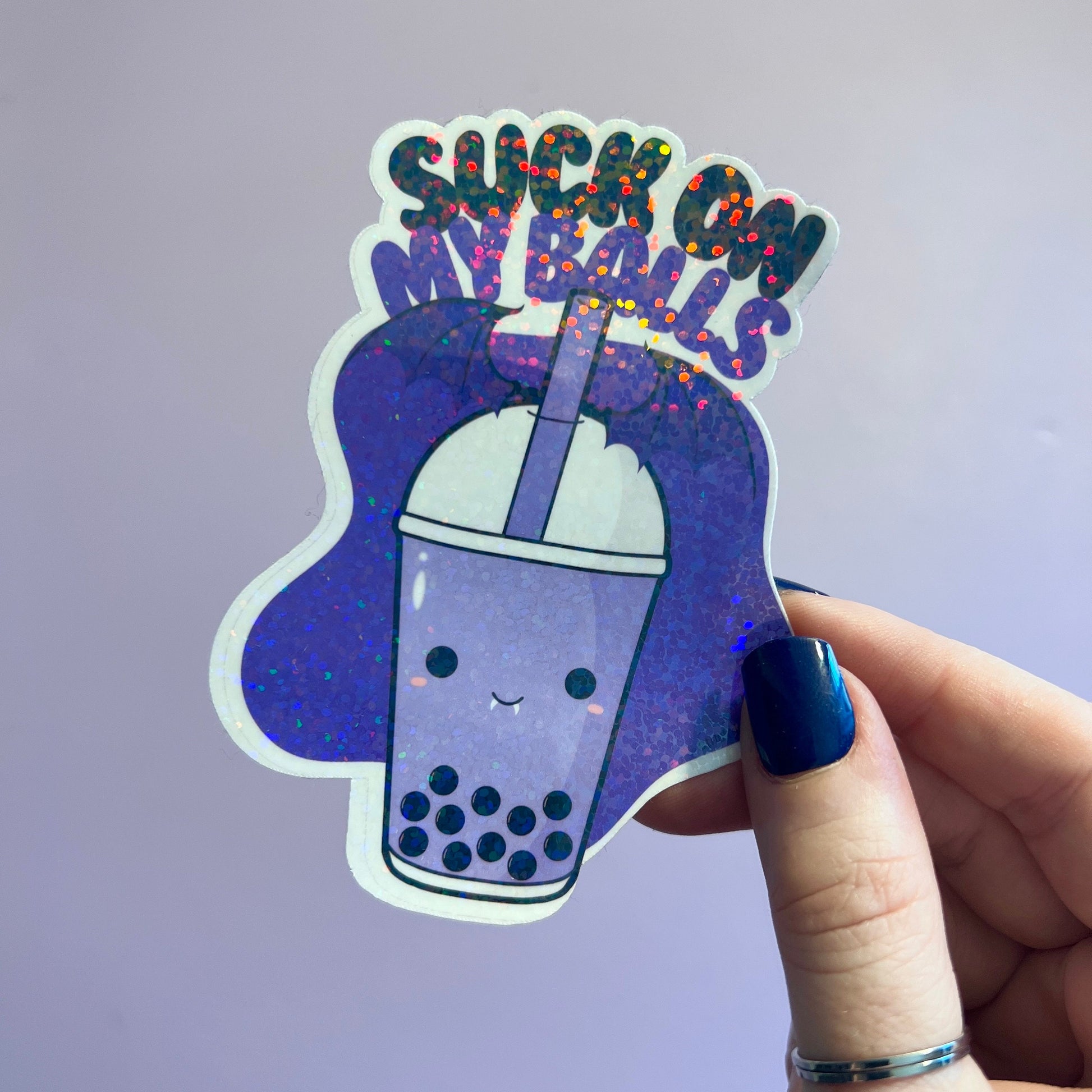 Holographic boba tea sticker with a cute bubble tea cup and the playful phrase Suck on My Balls in bold text. Perfect for decorating water bottles, laptops, and journals, this sassy and fun vinyl decal adds a quirky touch to your accessories.