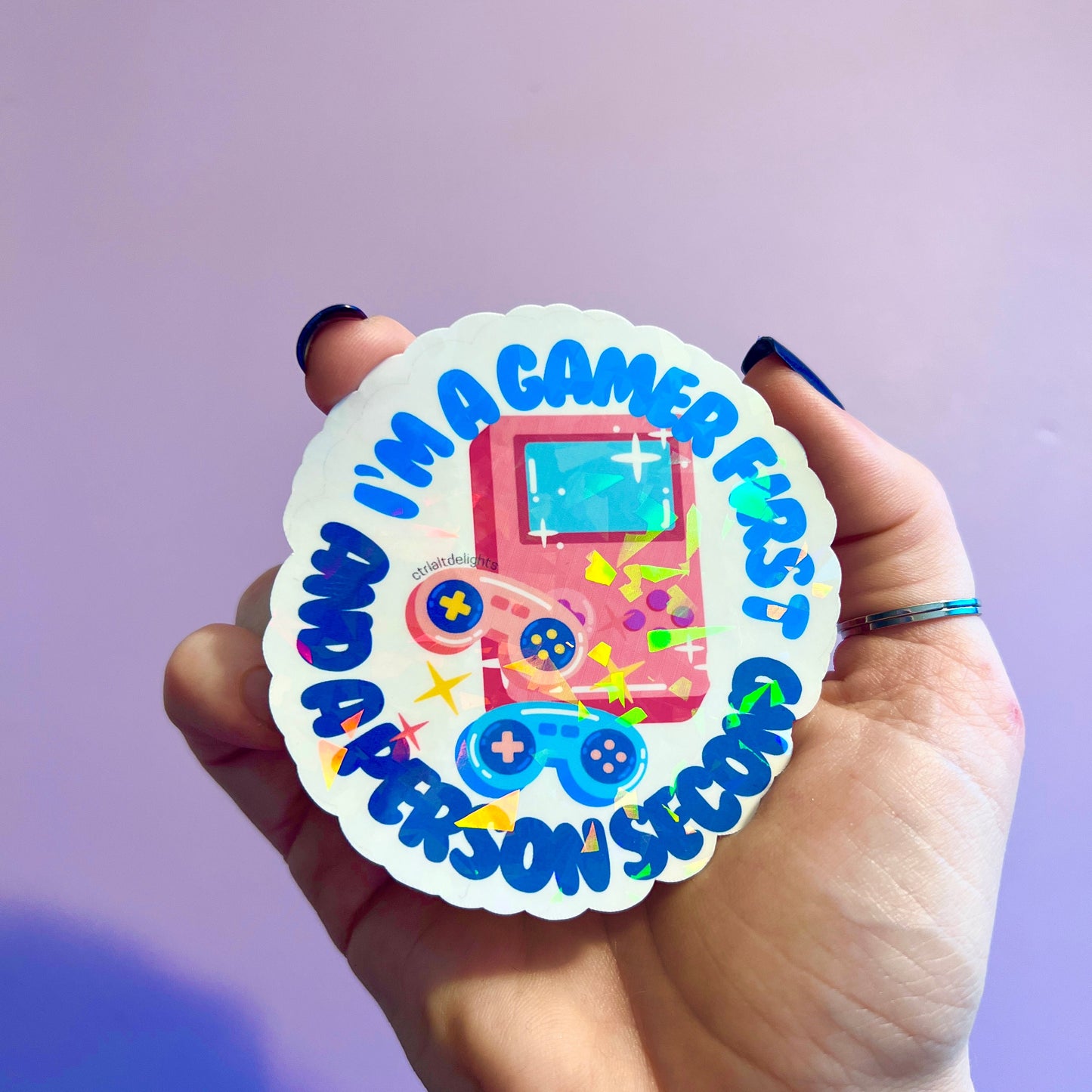 Colorful gaming sticker featuring a playful "I'm a Gamer First, Person Second" design. Perfect for personalizing laptops, water bottles, and gaming consoles. Great gift for gamers and geeks alike!